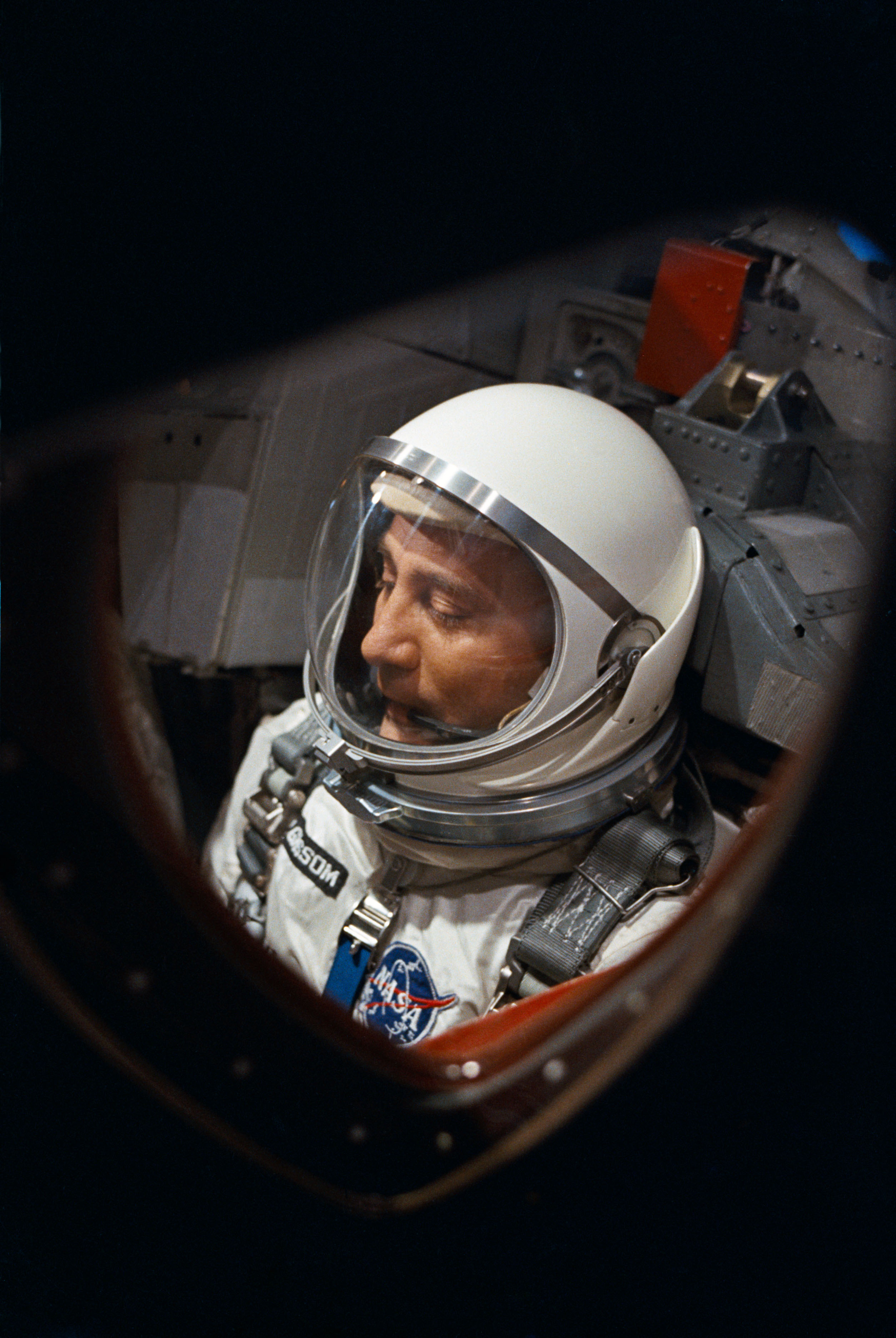 View of Astronaut Virgil Grissom through spacecraft window prior to launch