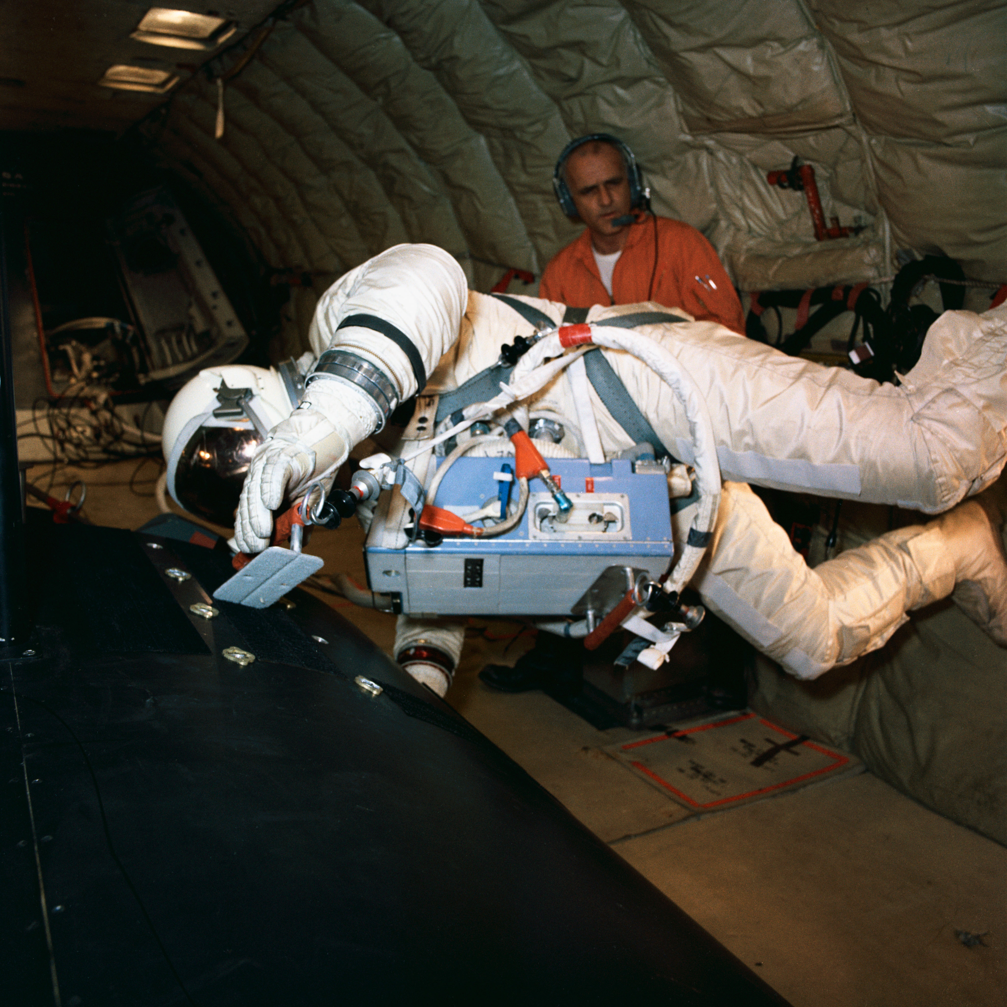 Astronaut Edwin Aldrin practices work task aboard KC-135
