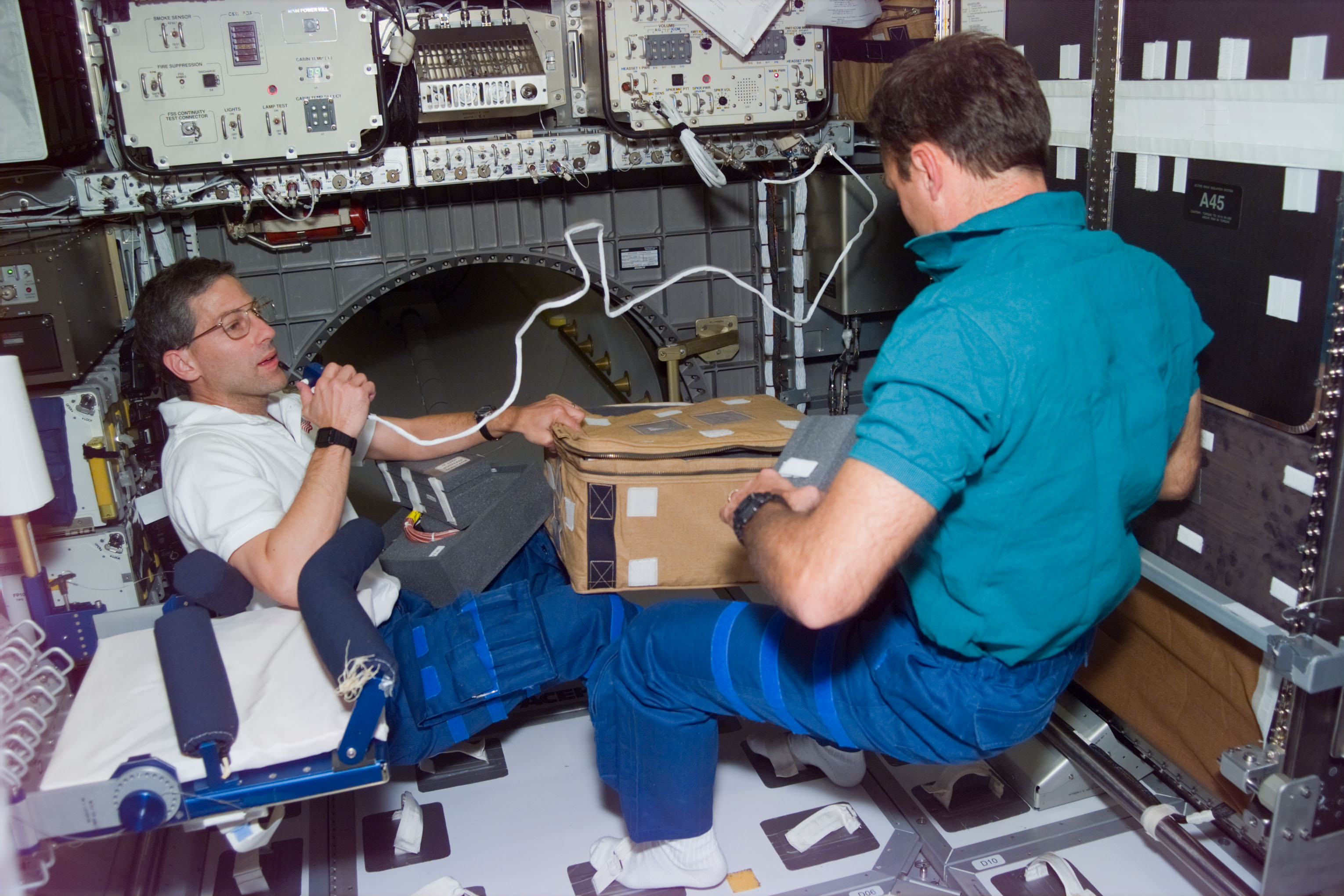 Astronauts Apt and Walz packed stowage items in the Spacehab