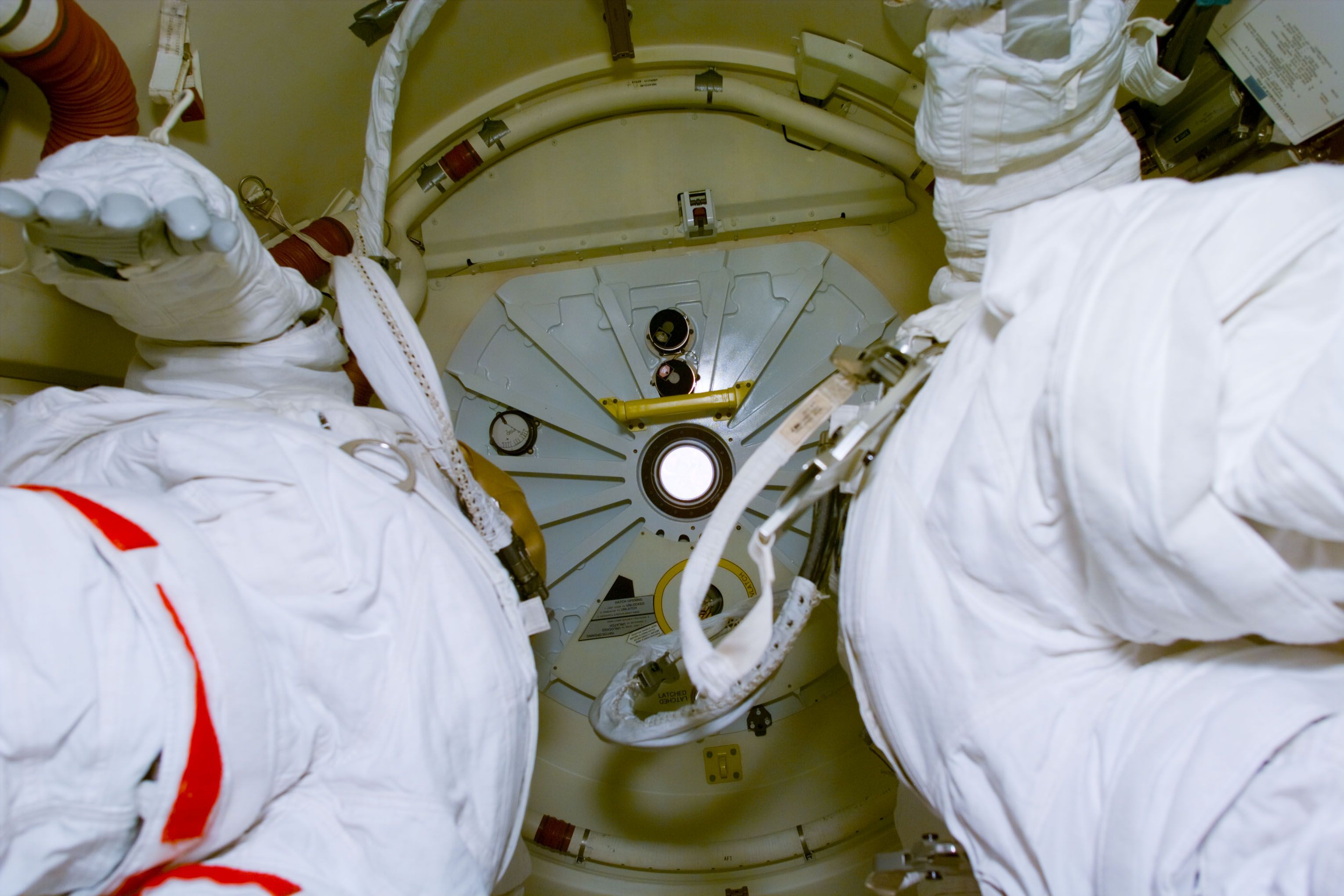Documentation of the external airlock interior with unstowed EMU suits