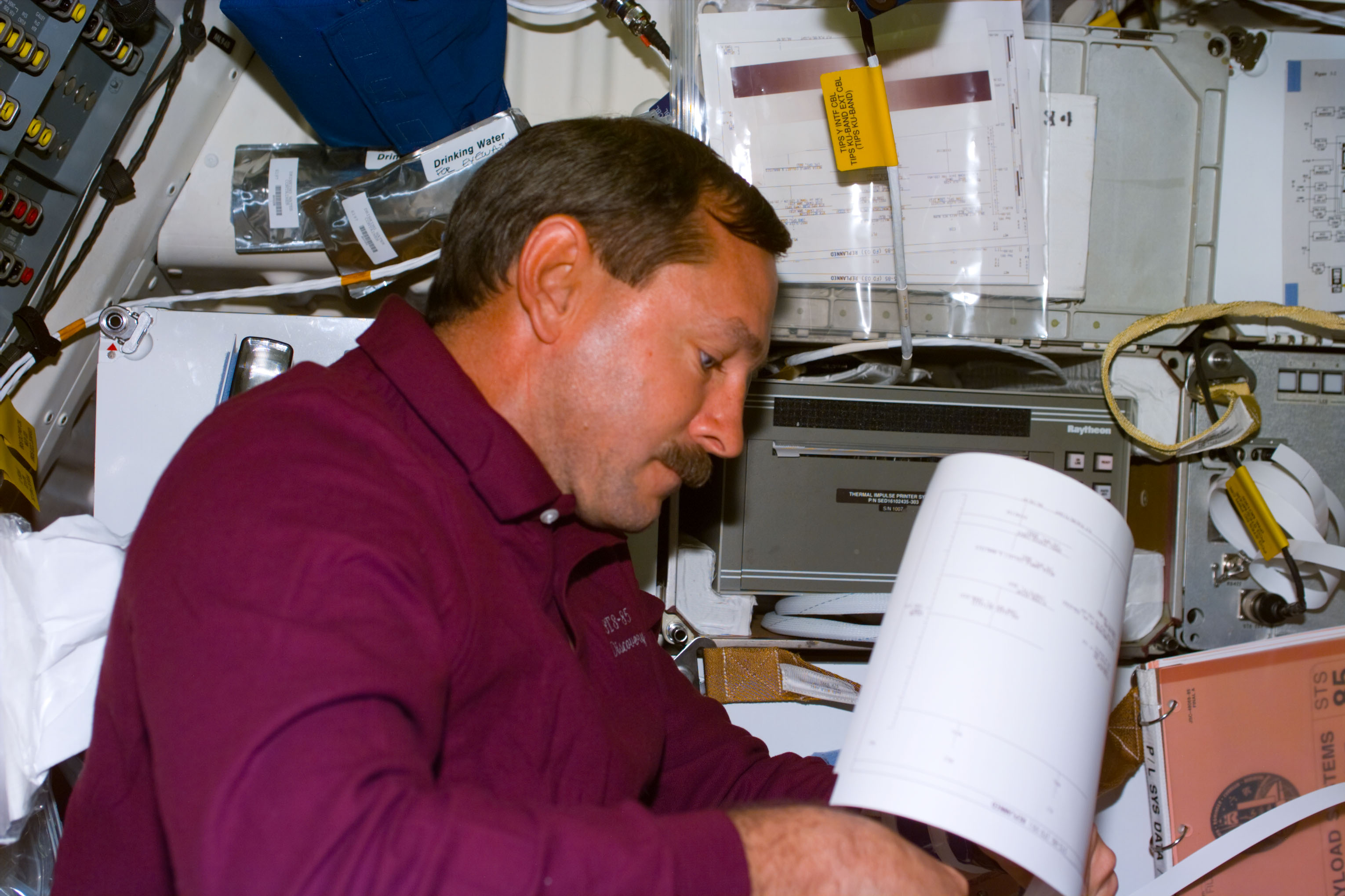 Candid views of STS-85 crewmembers in the middeck
