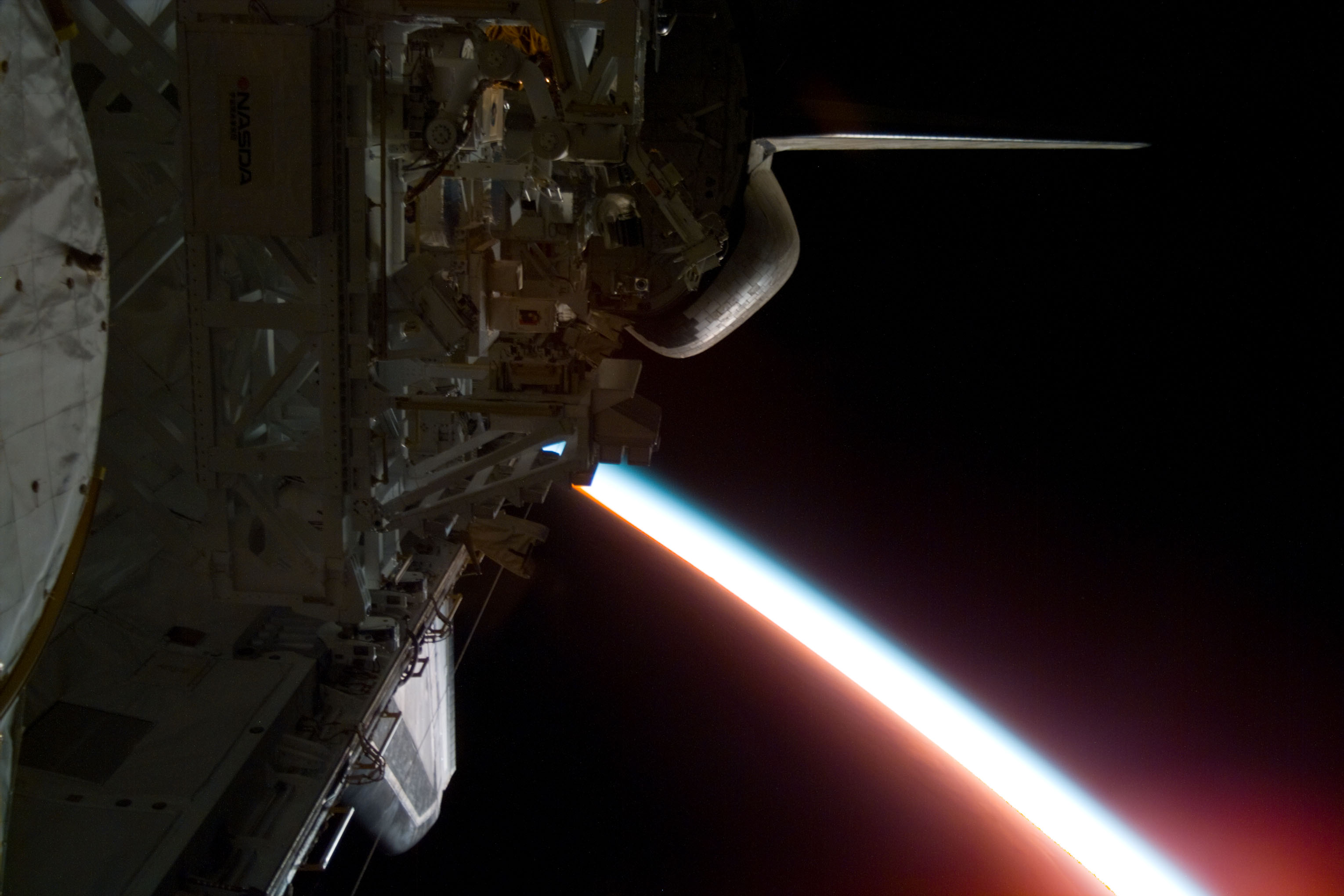 Illuminated Earth limb edge with MFD experiment visible in payload bay