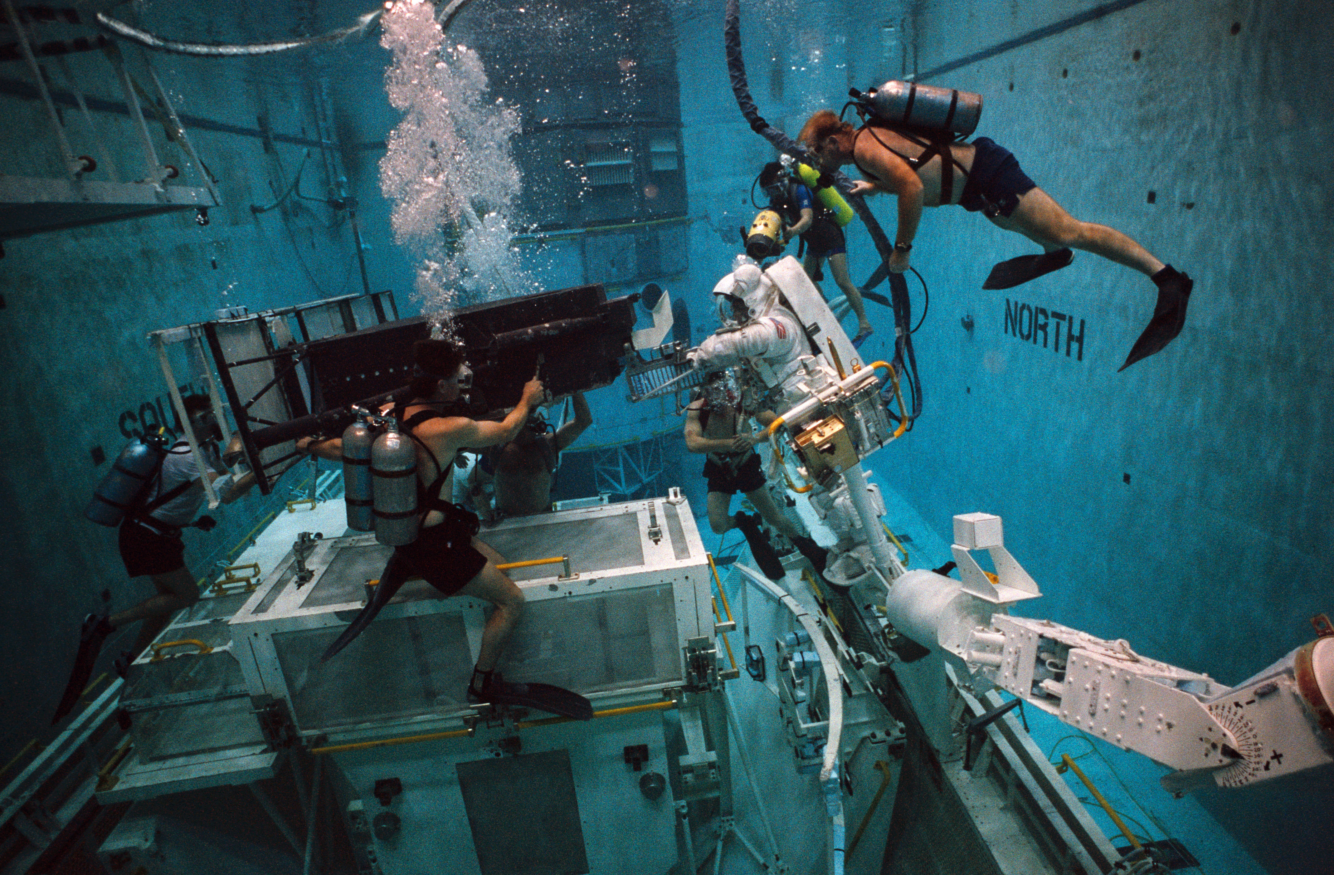 STS-61 crewmembers in the WETF rehearsing for HST repair mission