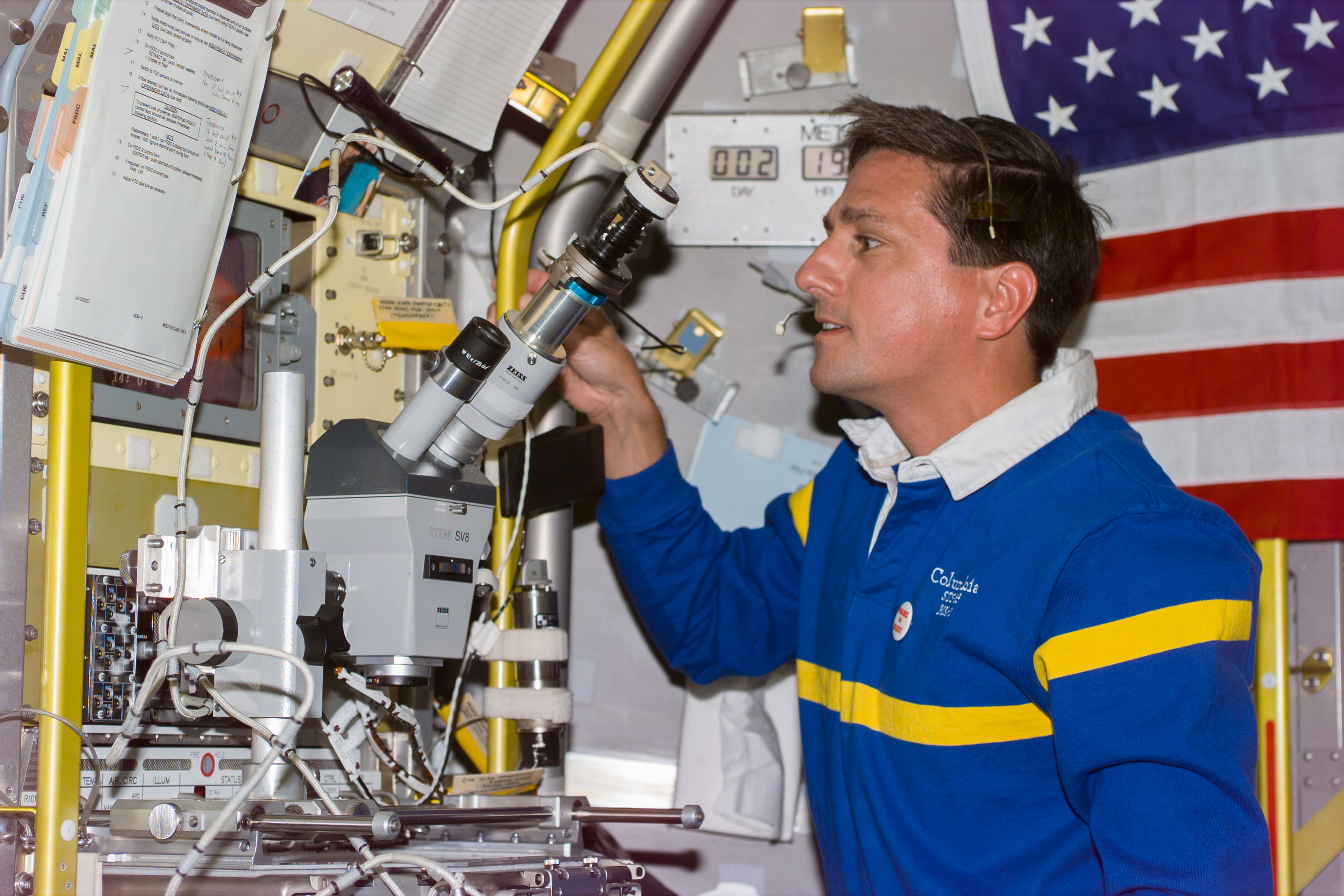 BDND - MGBX - Thomas with microscope at glovebox in Spacelab