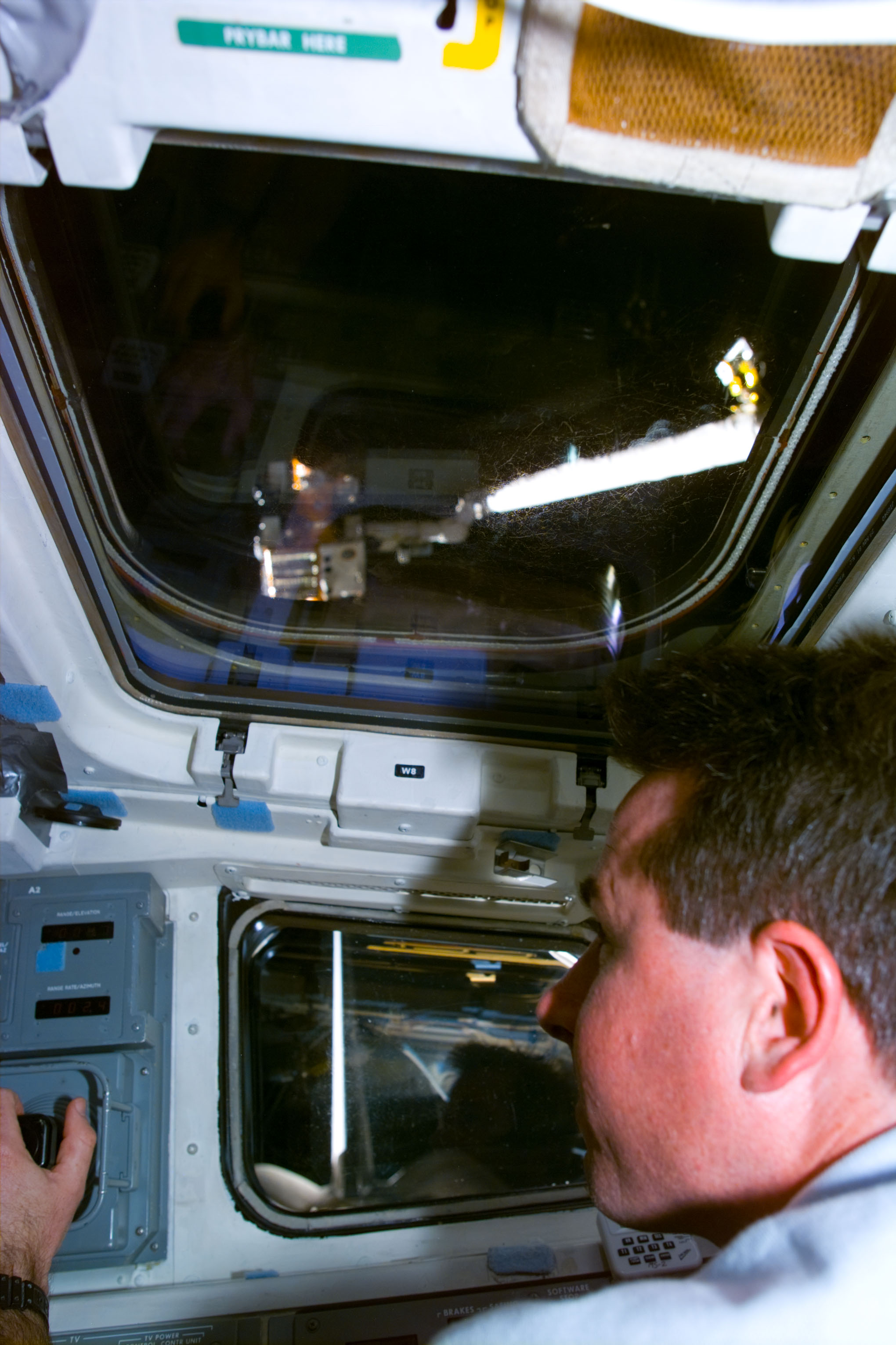 Robinson at RMS control on flight deck during SPARTAN capture