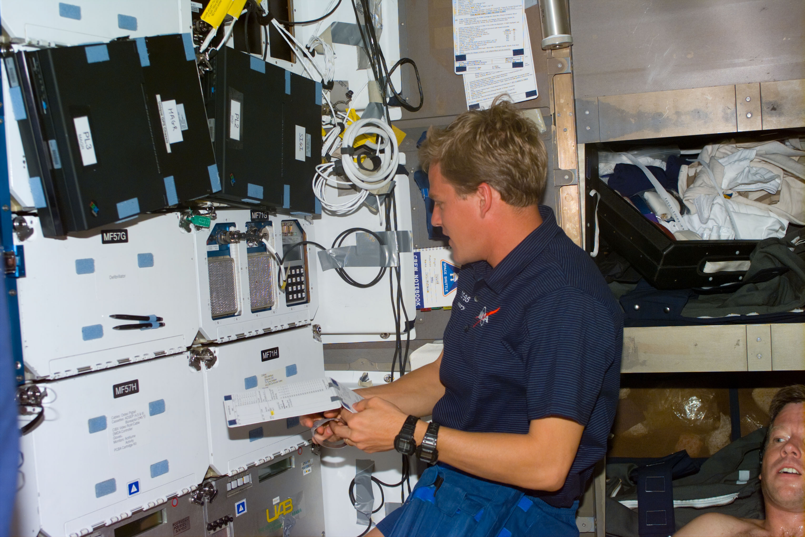 Parazynski reviews a checklist on the middeck