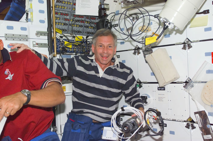 CDR Cockrell on middeck with camera