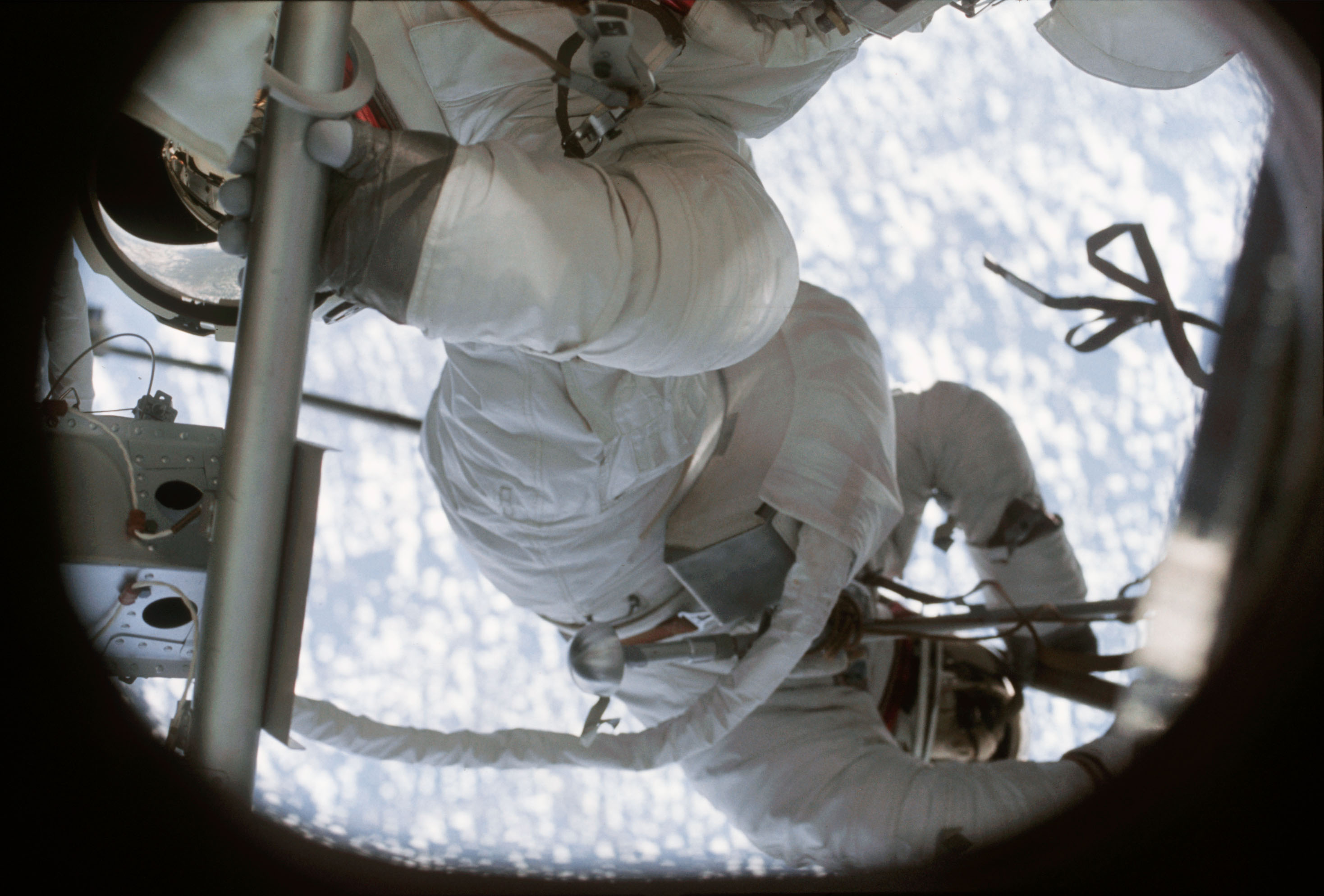 View of crewmen performing EVA taken from inside OWS