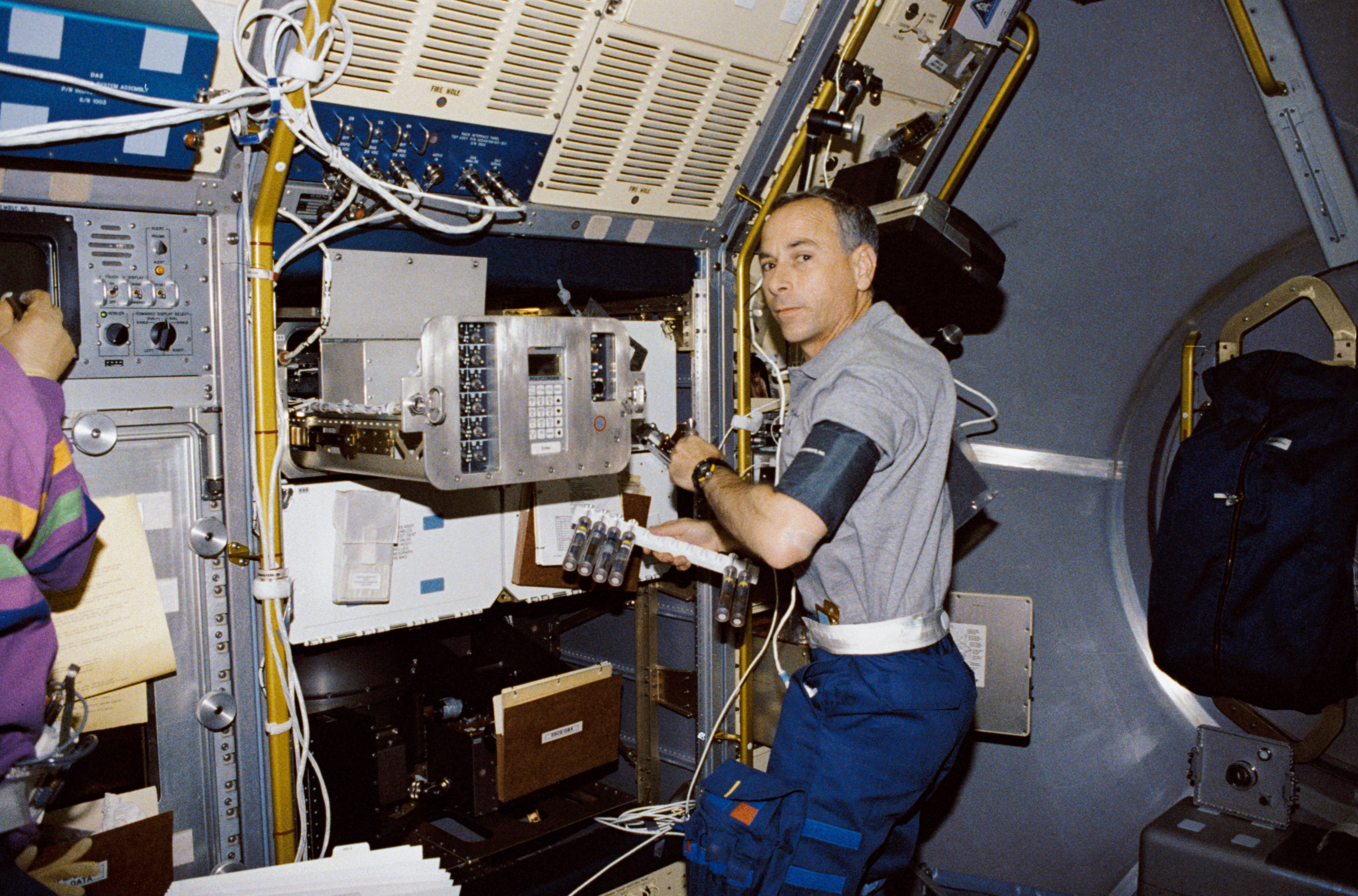 Crewmember in spacelab with the Generic Bioprocessing Apparatus, rack # 10.