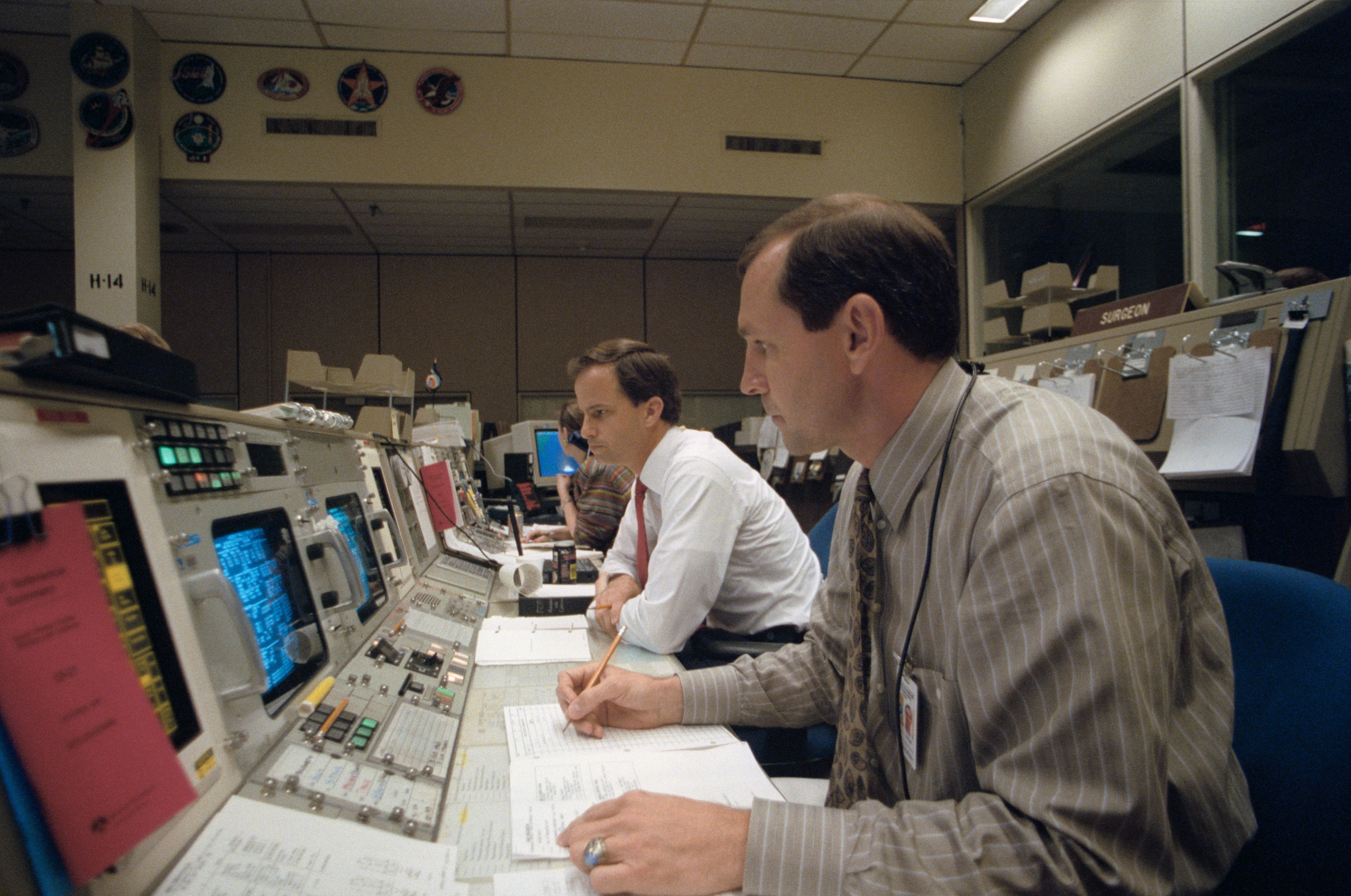STS-56 CAPCOMs Chilton and Brown monitor mission from a console at JSC MCC