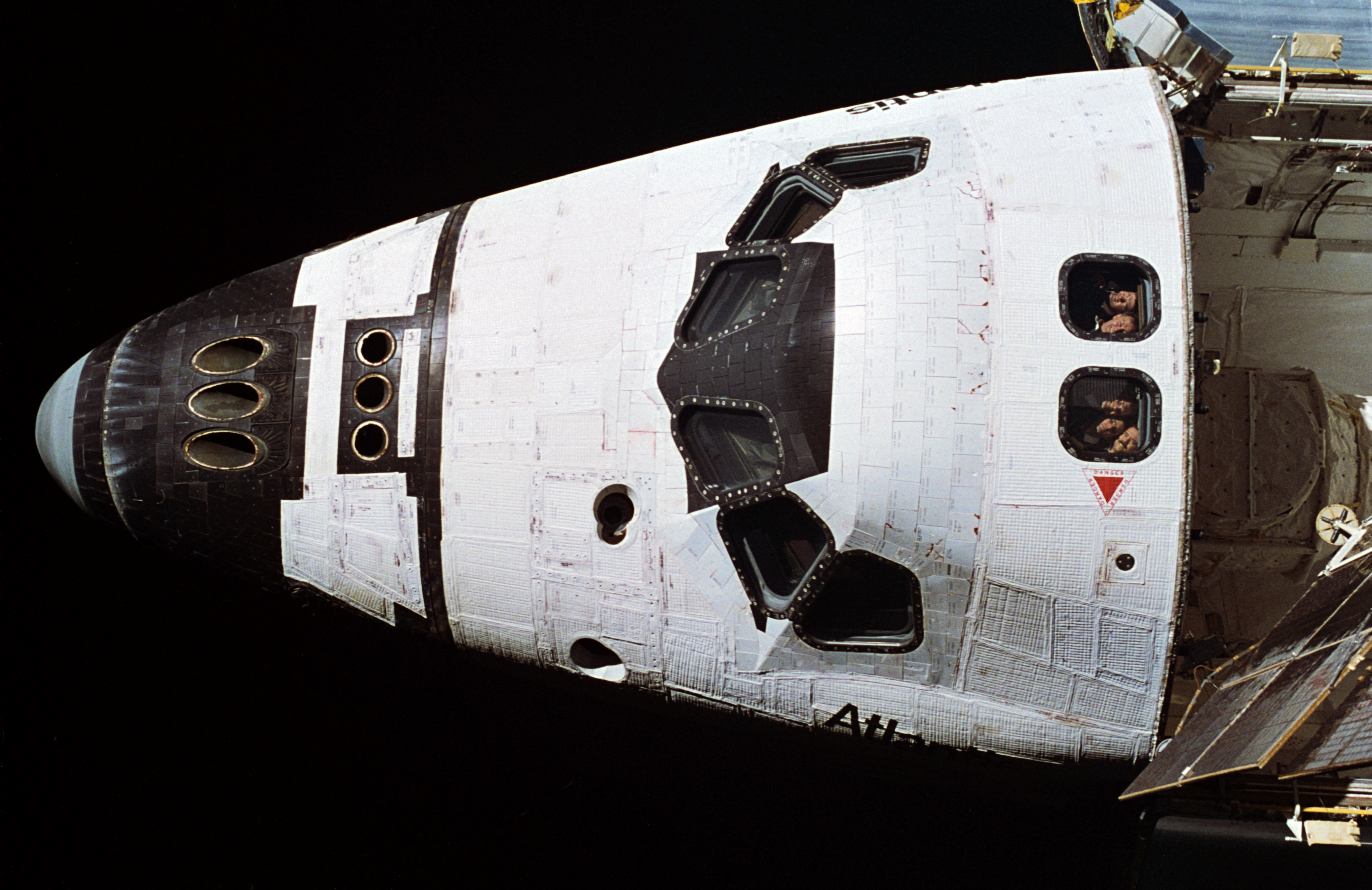 STS-74 crewmembers look out aft flight deck windows