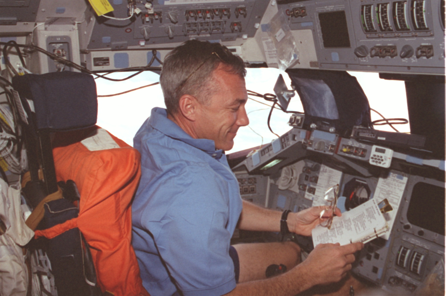 Cdr. Wilcutt reads documents at the command station