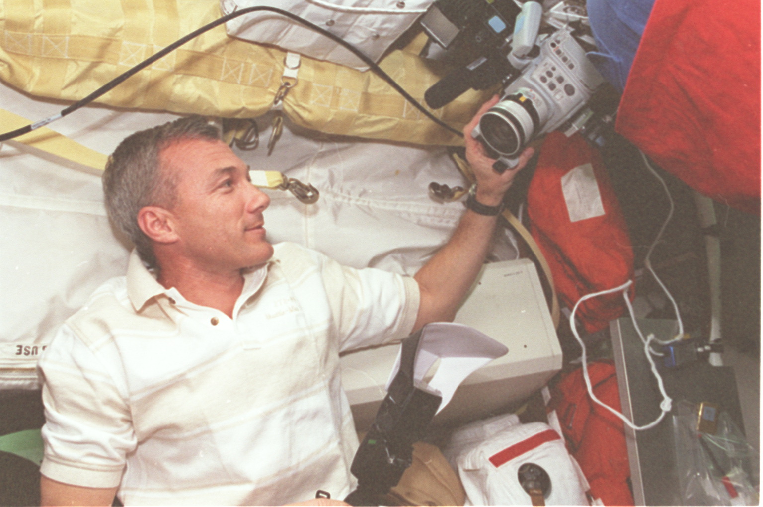 Cdr. Wilcutt adjusts a camcorder on middeck