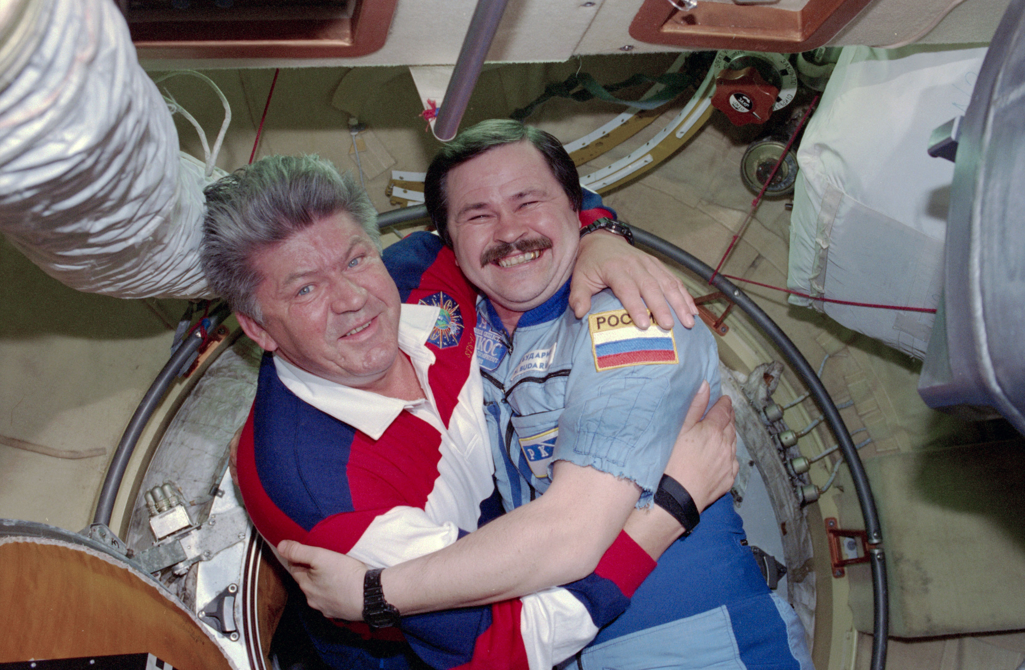 STS-91 crew is greeted at the hatch by Mir 25 crewmembers