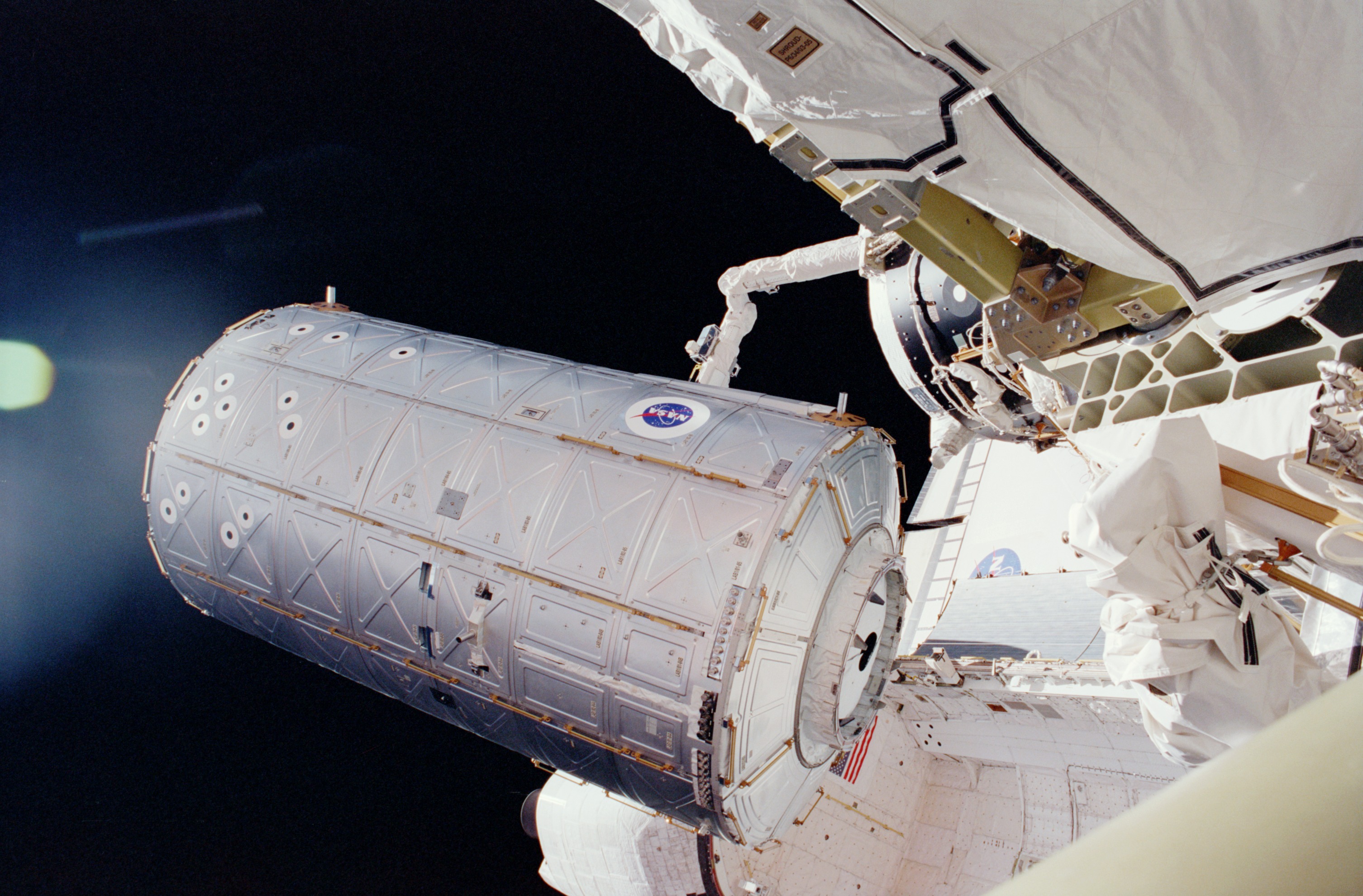 U.S. Destiny Laboratory Module held above Atlantis' PLB