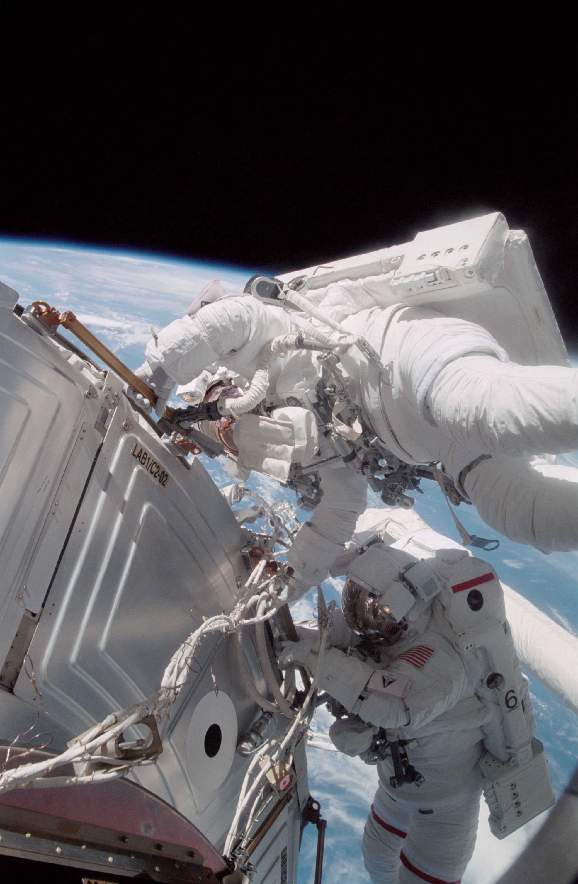 Forrester working with S0 cables on the LAB during EVA2