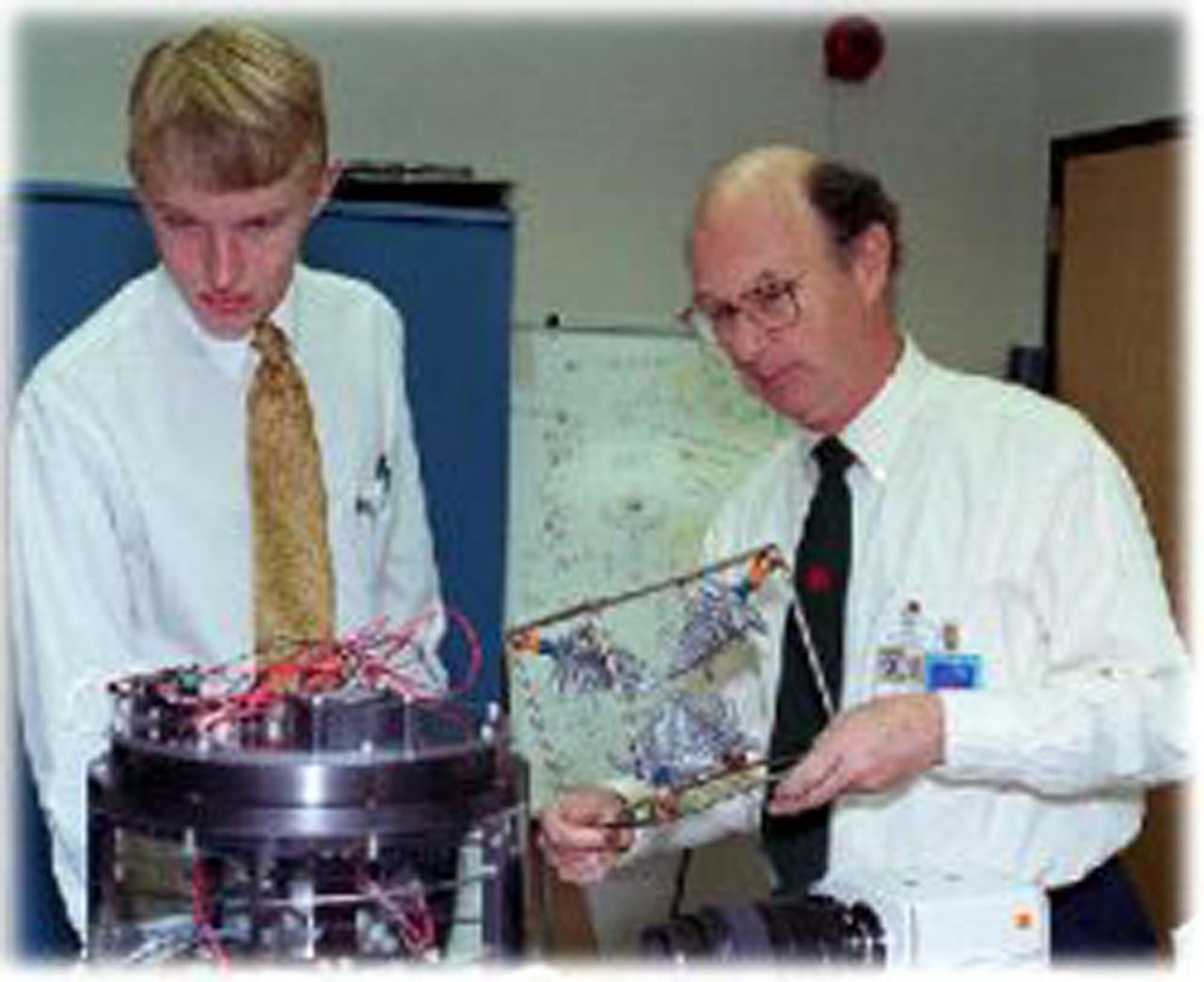 Dr. Donald Gilles, the Discipline Scientist for Materials Science in NASA's Microgravity Materials Science and Applications Department, demonstrates to Carl Dohrman a model of dendrites, the branch-like structures found in many metals and alloys. Dohrman was recently selected by the American Society for Metals International as their 1999 ASM International Foundation National Merit Scholar. The University of Illinois at Urbana-Champaign freshman recently toured NASA's materials science facilities at the Marshall Space Flight Center.