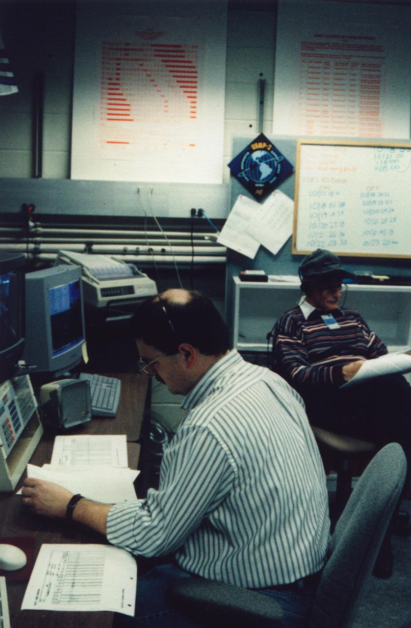 Matthew Koss (forground) and Martin Glicksman (rear), principal investigator and lead scientist (respectively), review plans for the next step in the Isothermal Dendritic Growth Experiment (IDGE) during the U.S. Microgravity Payload-4 (USMP-4) mission (STS-87, Nov. 19 - Dec. 5, 1997). Remote Operations Control Center (ROCC) like this one, at Rensselaer Polytechnic Institute (RPI) in Troy, NY, will become more common during operations with the International Space Station. IDGE, flown on three Space Shuttle missions, is yielding new insights into virtually all industrially relavent metal and alloy forming operations. Photo credit: Rensselaer Polytechnic Institute (RPI)