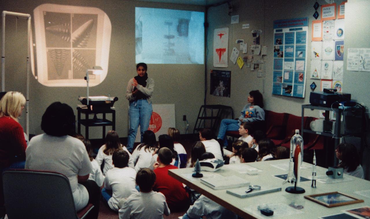 Pratima Rao lectures students about materials science research in space during the U.S. Microgravity Payload-4 (USMP-4) mission (STS-87, Nov. 19 - Dec. 5, 1997) in the visitor's center set up by the Isothermal Dendritic Growth Experiment (IDGE) team at Rensselaer Polytechnic Institute (RPI) in Troy, NY. IDGE, flown on three Space Shuttle missions, is yielding new insights into virtually all industrially relevant metal and alloy forming operations. Photo credit: RPI