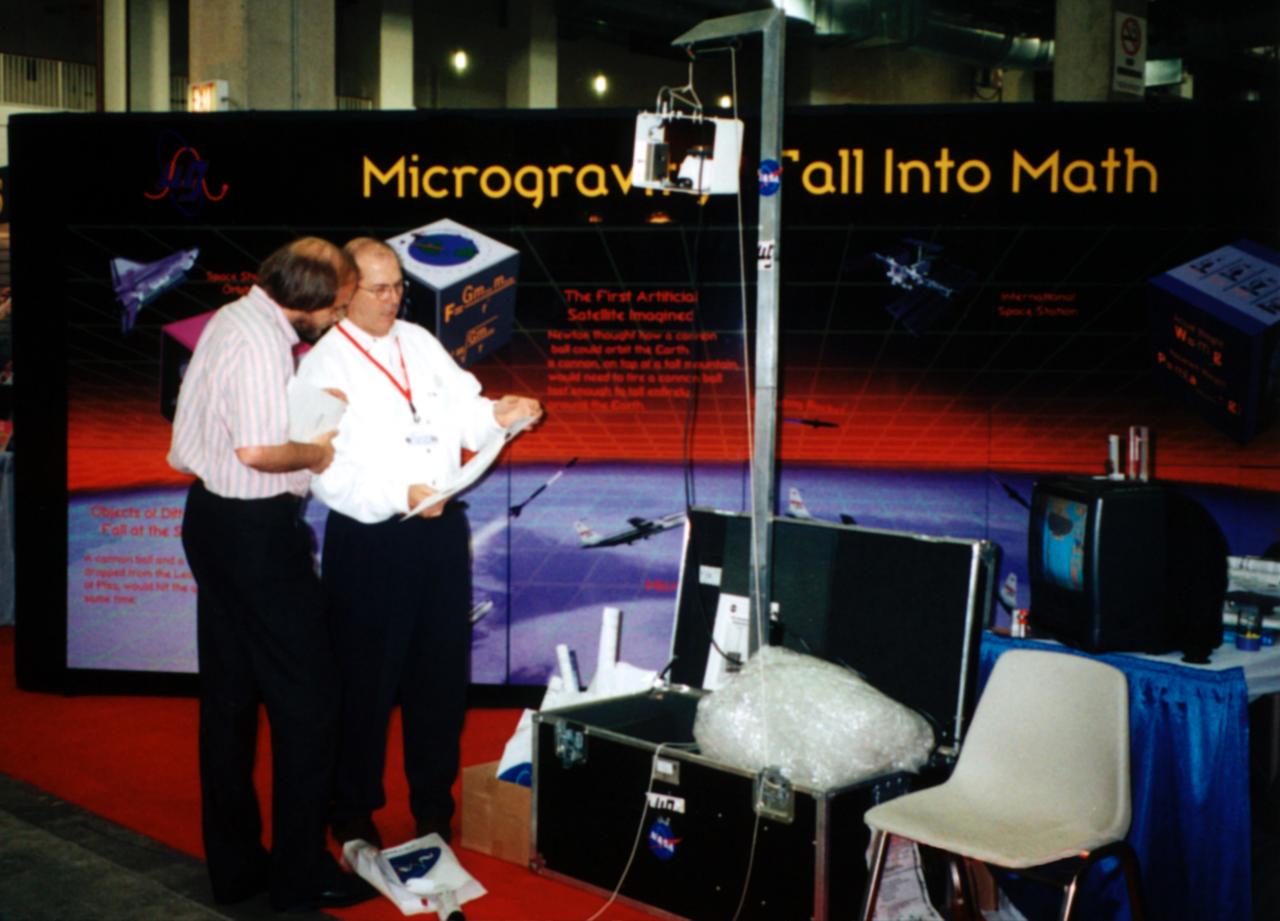 Jimmy Grisham of the Microgravity Program Plarning Integration Office at NASA/Marshall Space Flight Center, demonstrates the classroom-size Microgravity Drop Tower Demonstrator. The apparatus provides 1/6 second of microgravity for small experiments. A video camera helps teachers observe what happens inside the package. This demonstration was at the April 2000 conference of the National Council of Teachers of Mathematics (NCTM) in Chicago. Photo credit: NASA/Marshall Space Flight Center (MSFC) 