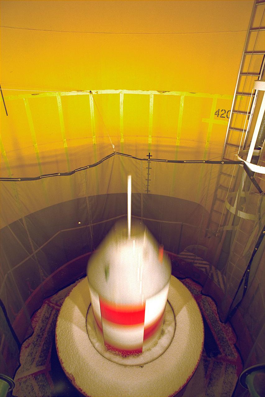 An experiment vehicle plunges into the deceleration pit at the end of a 5.18-second drop in the Zero-Gravity Research Facility at NASA's Glenn Research Center. The Zero-Gravity Research Facility was developed to support microgravity research and development programs that investigate various physical sciences, materials, fluid physcis, and combustion and processing systems. Payloads up to 1 meter in diameter and 455 kg in weight can be accommodated. The facility has a 145-meter evacuated shaft to ensure a disturbance-free drop. This is No. 2 of a sequence of 4 images. (Credit: NASA/Glenn Research Center)