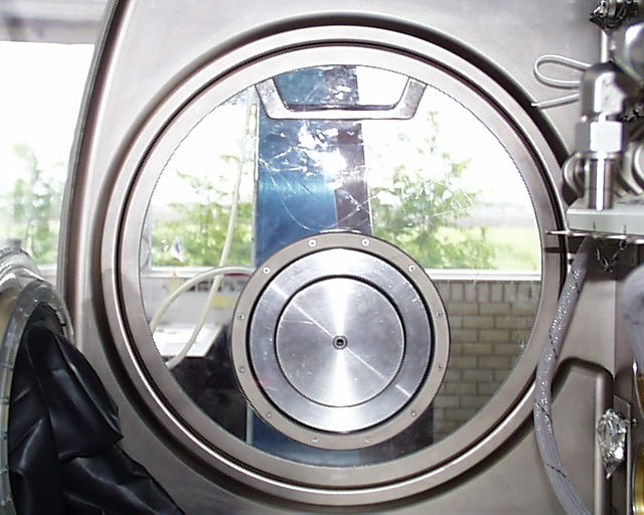 Access ports, one on each side of the Microgravity Science Glovebox (MSG), will allow scientists to place large experiment items inside the MSG. The ports also provide additional glove ports (silver disk) for greater access to the interior. The European Space Agency (ESA) and NASA are developing the MSG for use aboard the International Space Station (ISS). Scientists will use the MSG to carry out multidisciplinary studies in combustion science, fluid physics and materials science. The MSG is managed by NASA's Marshall Space Flight Center (MSFC). Photo Credit: NASA/MSFC