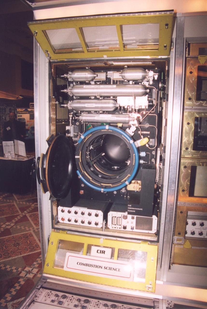 The combustion chamber for the Combustion Integrated Rack section of the Fluids and Combustion Facility (FCF) is shown opened for installation of burn specimens. The FCF will be installed, in phases, in the Destiny, the U.S. Laboratory Module of the International Space Station (ISS), and will accommodate multiple users for a range of investigations. This is an engineering mockup; the flight hardware is subject to change as designs are refined. The FCF is being developed by the Microgravity Science Division (MSD) at the NASA Glenn Research Center. (Photo credit: NASA/Marshall Space Flight Center)