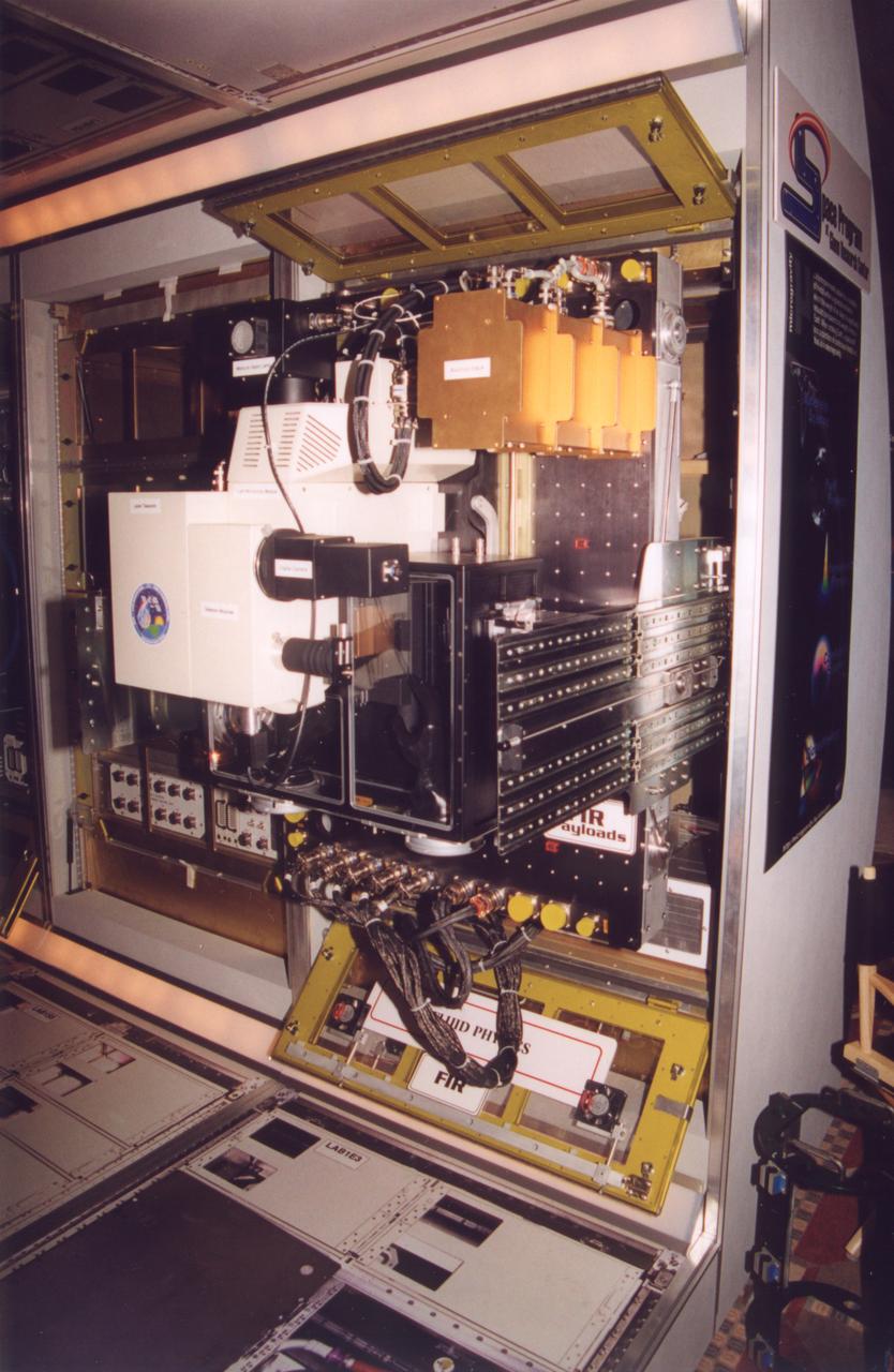 The optical bench for the Fluids Integrated Rack section of the Fluids and Combustion Facility (FCF) is shown extracted for servicing. The FCF will be installed, in phases, in the Destiny, the U.S. Laboratory Module of the International Space Station (ISS), and will accommodate multiple users for a range of investigations. This is an engineering mockup; the flight hardware is subject to change as designs are refined. The FCF is being developed by the Microgravity Science Division (MSD) at the NASA Glenn Research Center. (Photo credit: NASA/Marshall Space Flight Center)