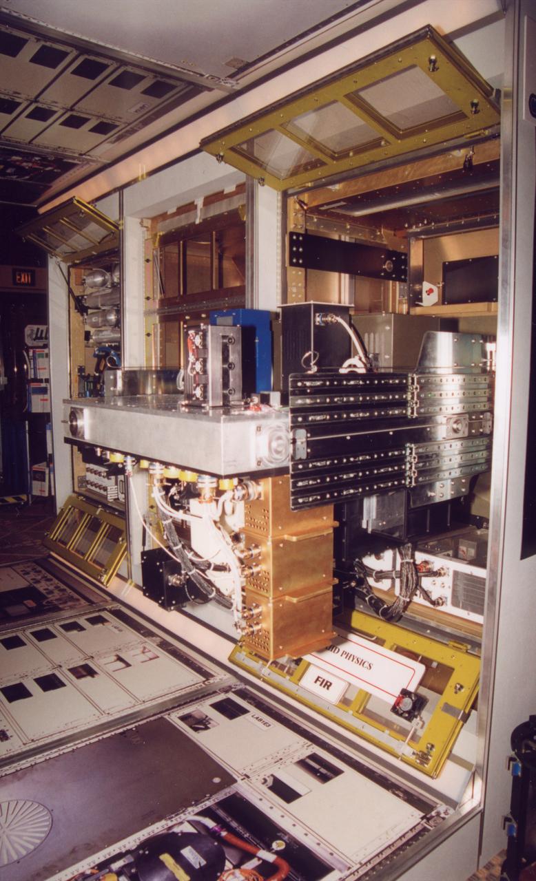 The optical bench for the Fluids Integrated Rack section of the Fluids and Combustion Facility (FCF) is shown extracted for servicing and with the optical bench rotated 90 degrees to access the rear elements. The FCF will be installed, in phases, in the Destiny, the U.S. Laboratory Module of the International Space Station (ISS), and will accommodate multiple users for a range of investigations. This is an engineering mockup; the flight hardware is subject to change as designs are refined. The FCF is being developed by the Microgravity Science Division (MSD) at the NASA Glenn Research Center. (Photo credit: NASA/Marshall Space Flight Center)