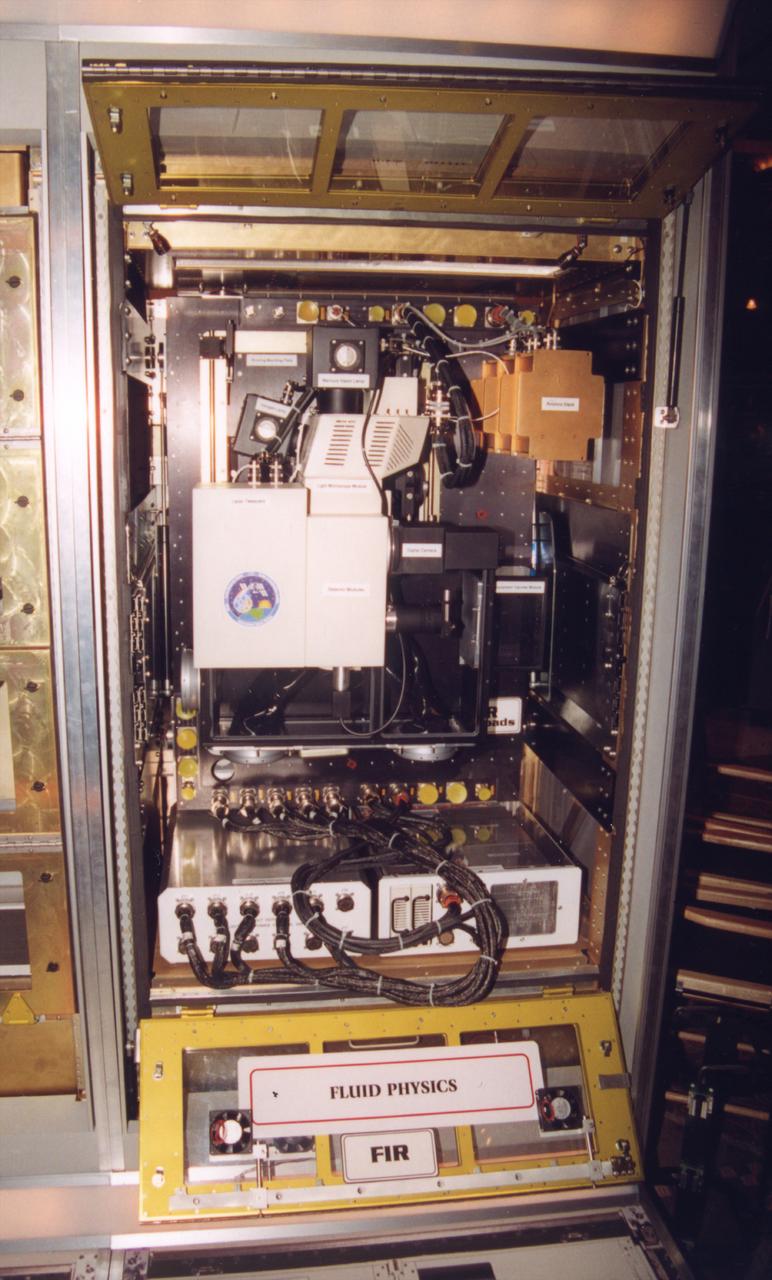 The optical bench for the Fluid Integrated Rack section of the Fluids and Combustion Facility (FCF) is shown in its operational configuration. The FCF will be installed, in phases, in the Destiny, the U.S. Laboratory Module of the International Space Station (ISS), and will accommodate multiple users for a range of investigations. This is an engineering mockup; the flight hardware is subject to change as designs are refined. The FCF is being developed by the Microgravity Science Division (MSD) at the NASA Glenn Research Center. (Photo credit: NASA/Marshall Space Flight Center)