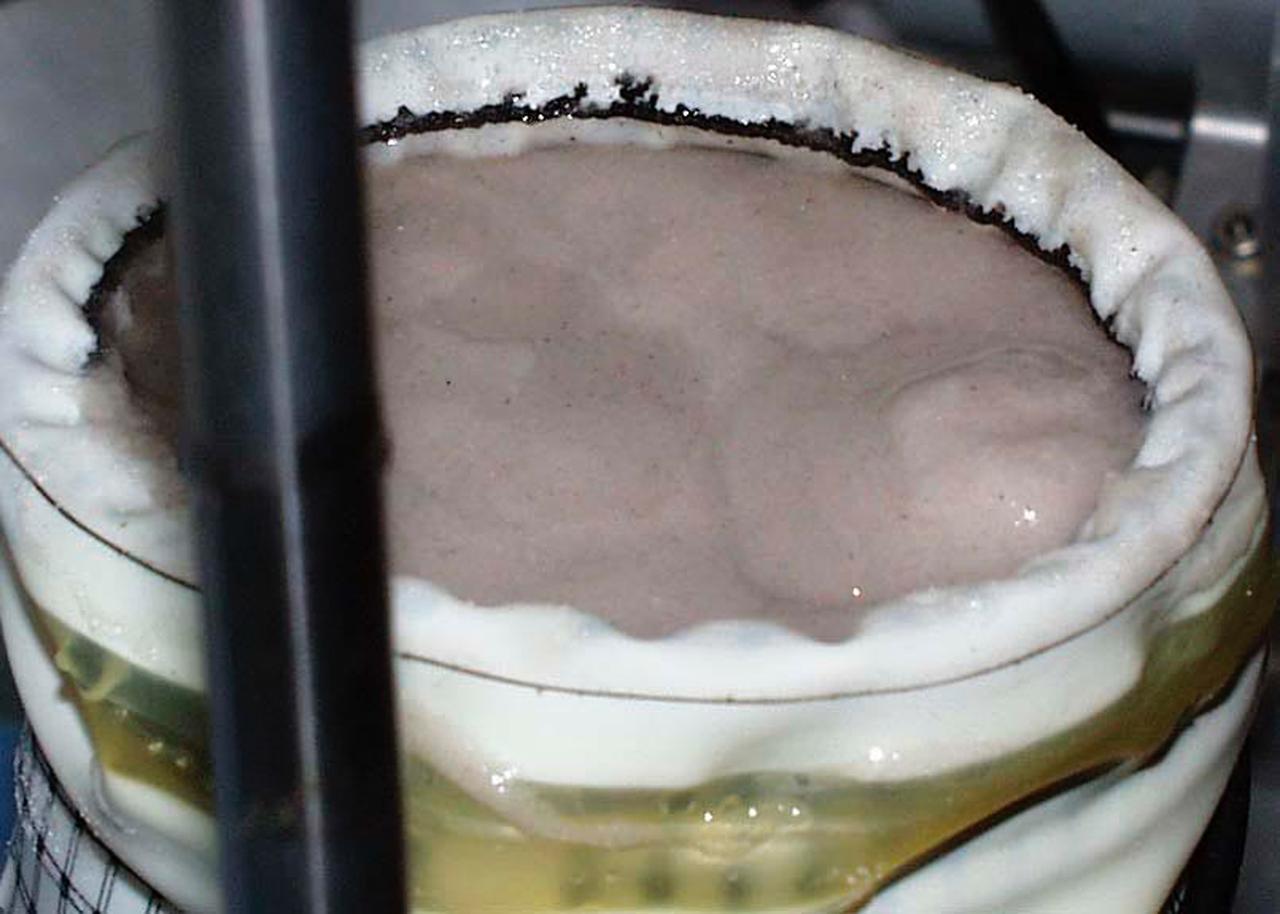 A test cell for Mechanics of Granular Materials (MGM) experiment is tested for long-term storage with water in the system as plarned for STS-107. This view shows the top of the sand column with the metal platten removed. Sand and soil grains have faces that can cause friction as they roll and slide against each other, or even cause sticking and form small voids between grains. This complex behavior can cause soil to behave like a liquid under certain conditions such as earthquakes or when powders are handled in industrial processes. Mechanics of Granular Materials (MGM) experiments aboard the Space Shuttle use the microgravity of space to simulate this behavior under conditons that cannot be achieved in laboratory tests on Earth. MGM is shedding light on the behavior of fine-grain materials under low effective stresses. Applications include earthquake engineering, granular flow technologies (such as powder feed systems for pharmaceuticals and fertilizers), and terrestrial and planetary geology. Nine MGM specimens have flown on two Space Shuttle flights. Another three are scheduled to fly on STS-107. The principal investigator is Stein Sture of the University of Colorado at Boulder. Credit: University of Colorado at Boulder
