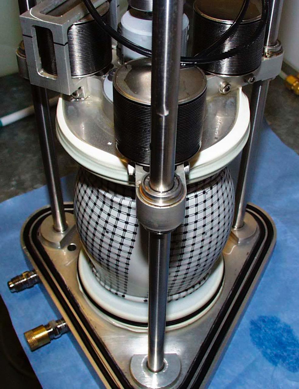 A test cell for Mechanics of Granular Materials (MGM) experiment is tested for long-term storage with water in the system as plarned for STS-107. This view shows the compressed sand column with the protective water jacket removed. Sand and soil grains have faces that can cause friction as they roll and slide against each other, or even cause sticking and form small voids between grains. This complex behavior can cause soil to behave like a liquid under certain conditions such as earthquakes or when powders are handled in industrial processes. Mechanics of Granular Materials (MGM) experiments aboard the Space Shuttle use the microgravity of space to simulate this behavior under conditons that cannot be achieved in laboratory tests on Earth. MGM is shedding light on the behavior of fine-grain materials under low effective stresses. Applications include earthquake engineering, granular flow technologies (such as powder feed systems for pharmaceuticals and fertilizers), and terrestrial and planetary geology. Nine MGM specimens have flown on two Space Shuttle flights. Another three are scheduled to fly on STS-107. The principal investigator is Stein Sture of the University of Colorado at Boulder. Credit: University of Colorado at Boulder