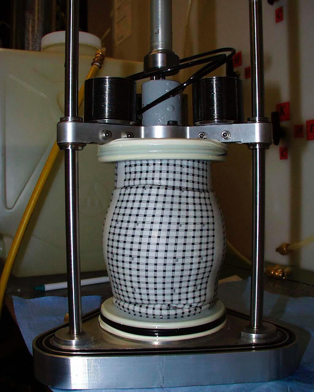A test cell for Mechanics of Granular Materials (MGM) experiment is tested for long-term storage with water in the system as plarned for STS-107. This view shows the compressed sand column with the protective water jacket removed. Sand and soil grains have faces that can cause friction as they roll and slide against each other, or even cause sticking and form small voids between grains. This complex behavior can cause soil to behave like a liquid under certain conditions such as earthquakes or when powders are handled in industrial processes. Mechanics of Granular Materials (MGM) experiments aboard the Space Shuttle use the microgravity of space to simulate this behavior under conditons that cannot be achieved in laboratory tests on Earth. MGM is shedding light on the behavior of fine-grain materials under low effective stresses. Applications include earthquake engineering, granular flow technologies (such as powder feed systems for pharmaceuticals and fertilizers), and terrestrial and planetary geology. Nine MGM specimens have flown on two Space Shuttle flights. Another three are scheduled to fly on STS-107. The principal investigator is Stein Sture of the University of Colorado at Boulder. Credit: University of Colorado at Boulder