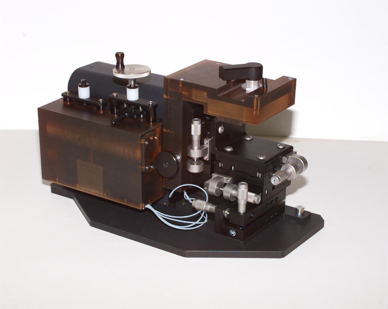 The Interferometer Protein Crstal Growth (IPCG) experiment was designed to measure details of how protein molecules move through a fluid. It was flown on the STS-86 mission for use aboard Russin Space Station Mir in 1998. It studied aspects of how crystals grow - and what conditions lead to the best crystals, details that remain a mystery. IPCG produces interference patterns by splitting then recombining laser light. This let scientists see how fluid densities - and molecular diffusion - change around a crystal as it grows in microgravity. The heart of the IPCG apparatus is the interferometer cell comprising the optical bench, microscope, other optics, and video camera. IPCG experiment cells are made of optical glass and silvered on one side to serve as a mirror in the interferometer system that visualizes crystals and conditions around them as they grow inside the cell. This view shows the complete apparatus. The principal investigator was Dr. Alexander McPherson of the University of California, Irvin. Co-investigators are William Witherow and Dr. Marc Pusey of NASA's Marshall Space Flight Center 