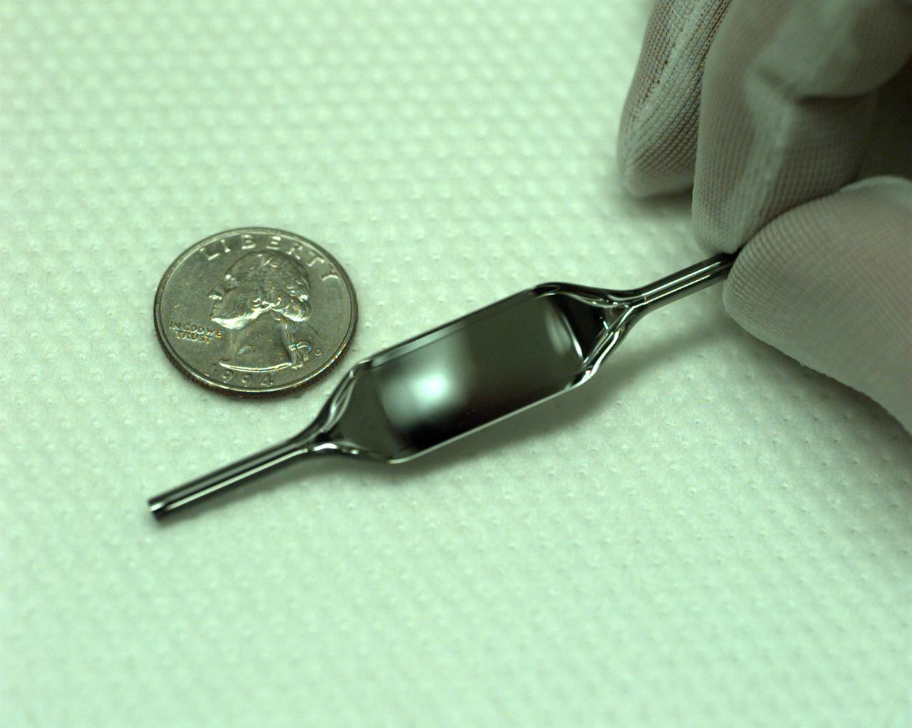 The Interferometer Protein Crystal Growth (IPCG) experiment was designed to measure details of how protein molecules move through a fluid. It was flown on the STS-86 mission for use aboard Russian Space Station Mir in 1998. It studied aspects of how crystals grow - and what conditions lead to the best crystals, details that remain a mystery. IPCG produces interference patterns by spilitting then recombining laser light. This let scientists see how fluid densities - and molecular diffusion - change around a crystal as it grows in microgravity. The heart of the IPCG apparatus is the interferometer cell comprising the optical bench, microscope, other optics, and video camera. IPCG experiment cells are made of optical glass and silvered on one side to serve as a mirror in the interferometer system that visuzlizes crystals and conditions around them as they grow inside the cell. This view shows a large growth cell. The principal investigator was Dr. Alexander McPherson of University of California, Irvine. Co-investigators are William Witherow and Dr. Marc Pusey of NASA's Marshall Space Flight Center (MSFC).