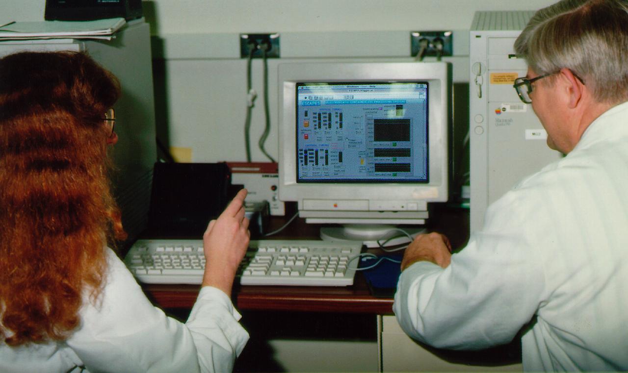 Dr. Jan Rogers and Dr. Michael Robinson operate the Electrostatic Levitator (ESL) at NASA's Marshall Space Flight Center (MSFC). The ESL uses static electricity to suspend an object (about 2-3 mm in diameter) inside a vacuum chamber while a laser heats the sample until it melts. This lets scientists record a wide range of physical properties without the sample contacting the container or any instruments, conditions that would alter the readings. The Electrostatic Levitator is one of several tools used in NASA's microgravity materials science program.
