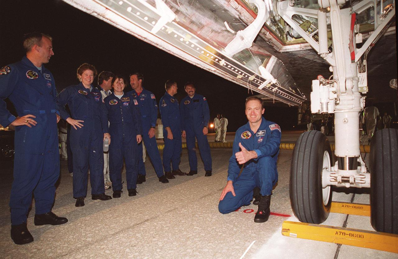 KENNEDY SPACE CENTER, FLA. -- STS-101 Commander James D. Halsell Jr. gives a thumbs up after looking at the perfect wheel stop that straddles the center line on Runway 15 of KSC’s Shuttle Landing Facility. The other crew members standing at left are Mission Specialists Jeffrey N. Williams, Susan J. Helms, Mary Ellen Weber; Pilot Scott “Doc” Horowitz; and Mission Specialists James S. Voss and Yury Usachev. The STS-101 crew returned from the third flight to the International Space Station, providing maintenance and carrying supplies for future missions. Main gear touchdown was at 2:20:17 a.m. EDT May 29 , landing on orbit 155 of the mission. Nose gear touchdown was at 2:20:30 a.m. EDT, and wheel stop at 2:21:19 a.m. EDT. This was the 98th flight in the Space Shuttle program and the 21st for Atlantis, also marking the 51st landing at KSC, the 22nd consecutive landing at KSC, the 14th nighttime landing in Shuttle history and the 29th in the last 30 Shuttle flights