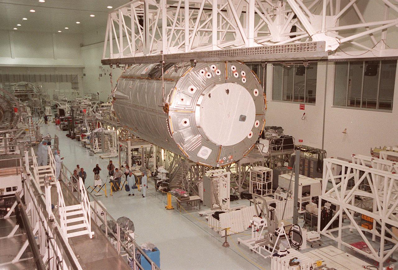 KENNEDY SPACE CENTER, FLA. -- The U.S. Laboratory Destiny travels past the Multi-Purpose Logistics Module Leonardo in its overhead passage down the Space Station Processing Facility. The lab is being moved to the Launch Package Integration Stand (LPIS) for a weight and center of gravity determination. Destiny is the payload aboard Space Shuttle Atlantis on mission STS-98 to the Space Station. The lab is fitted with five system racks and will already have experiments installed inside for the flight. The launch is scheduled for January 2001