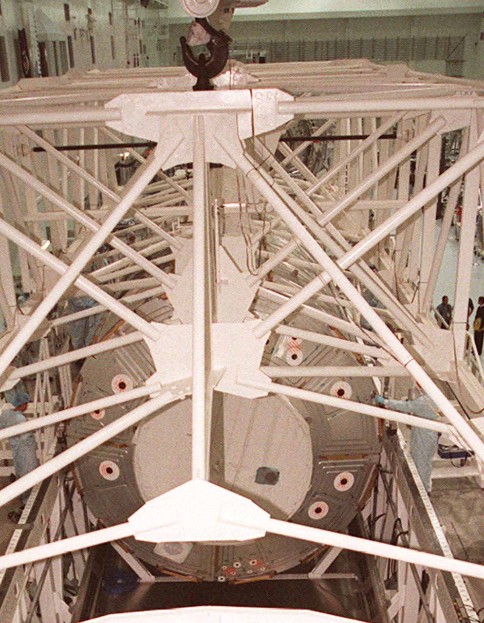 KENNEDY SPACE CENTER, FLA. -- In the Space Station Processing Facility, the overhead crane above the U.S. Lab Destiny is ready to be removed. Destiny rests in the Launch Package Integration Stand (LPIS) for a weight and center of gravity determination. In the foreground is the scale. Destiny is the payload aboard Space Shuttle Atlantis on mission STS-98 to the Space Station. The lab is fitted with five system racks and will already have experiments installed inside for the flight. The launch is scheduled for January 2001