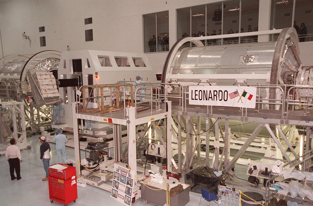 KENNEDY SPACE CENTER, FLA. -- In the Space Station Processing Facility, the Multi-Purpose Logistics Module Leonardo (right) is ready for installation of a laboratory rack (left center). Leonardo is the first of three such pressurized modules that will serve as the International Space Station's “moving vans,” carrying laboratory racks filled with equipment, experiments and supplies to and from the Space Station aboard the Space Shuttle. Approximately 21 feet long and 15 feet in diameter, Leonardo will be launched on Shuttle mission STS-102 March 1, 2001. On that flight, Leonardo will be filled with equipment and supplies to outfit the U.S. laboratory module, being carried to the ISS on the Jan. 19, 2001, launch of STS-98