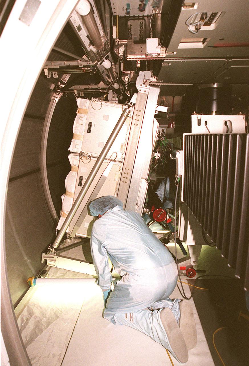 KENNEDY SPACE CENTER, FLA. -- Inside the Multi-Purpose Logistics Module Leonardo, a worker looks at the placement of a laboratory rack. The MPLM is the first of three such pressurized modules that will serve as the International Space Station’s “moving vans,” carrying laboratory racks filled with equipment, experiments and supplies to and from the Space Station aboard the Space Shuttle. Leonardo will be launched March 1, 2001, on Shuttle mission STS-102 On that flight, Leonardo will be filled with equipment and supplies to outfit the U.S. laboratory module, being carried to the ISS on the Jan. 19, 2001, launch of STS-98