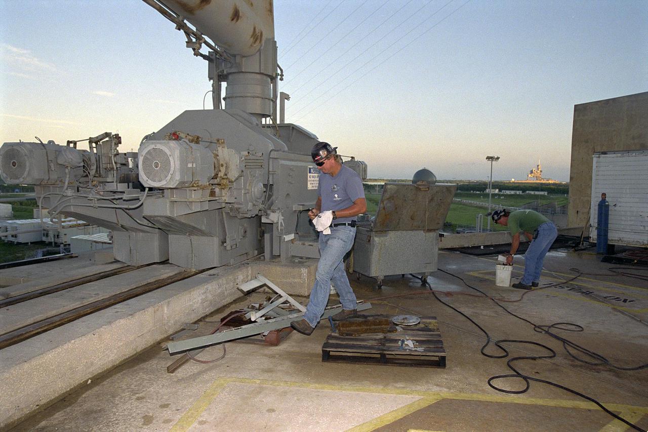 KENNEDY SPACE CENTER, FLA. -- Day in the Life, page 2. Preparing the pad. Workers maintain Pad A at Kennedy Space Center’s Launch Complex 39. Jack Hanover of SDB Engineers and Constructors Inc. prepares to change a bearing in the Rotating Service Structure. This photograph was taken for a special color edition of Spaceport News designed to portray in photographs a single day at KSC, July 26, 2000. The special edition, published Aug. 25, 2000, was created to give readers a look at KSC’s diverse workforce and the critical roles workers play in the nation’s space program. Spaceport News is an official publication of the Kennedy Space Center and is published on alternate Fridays by the Public Affairs Office in the interest of KSC civil service and contractor employees