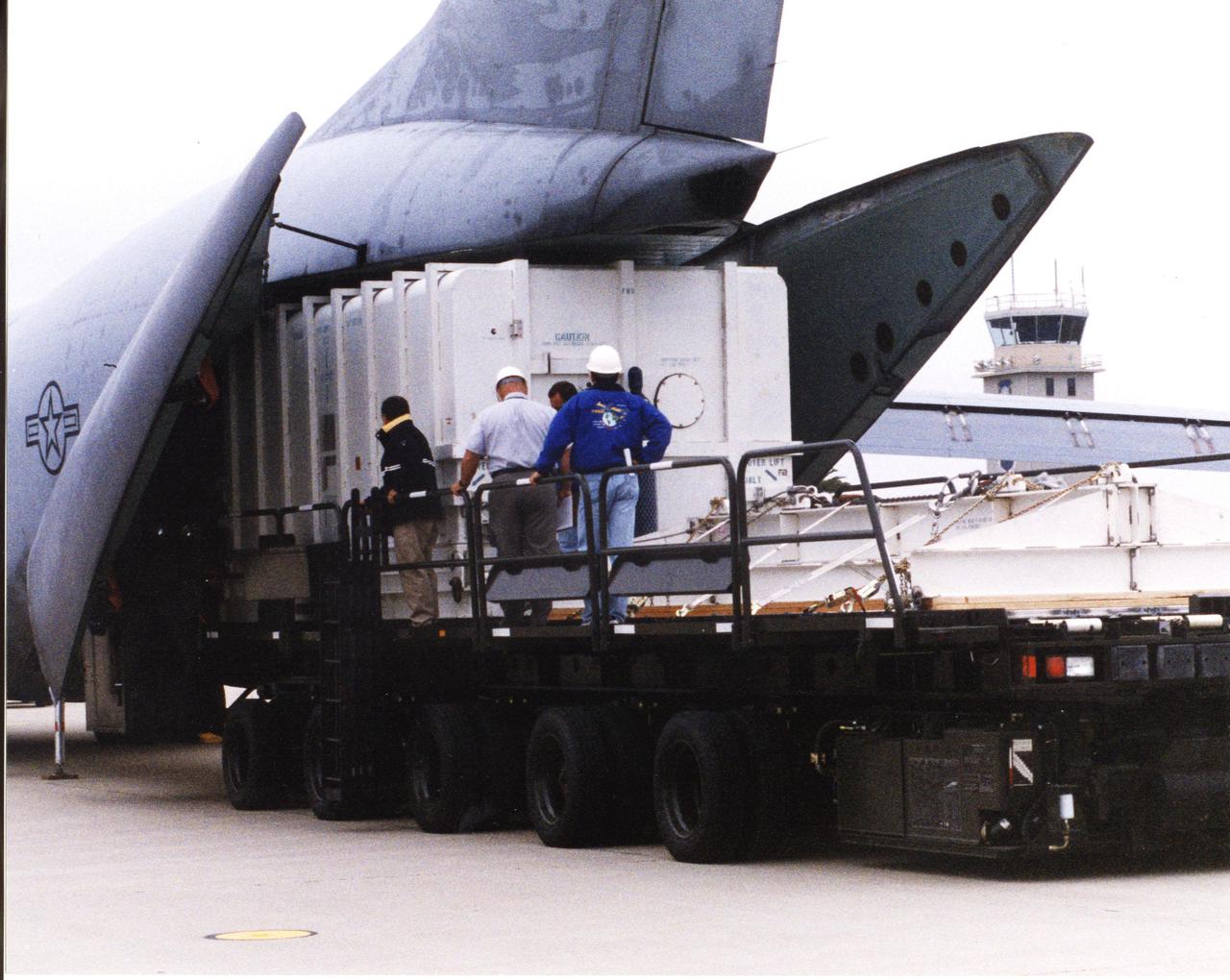 A crated National Oceanic and Atmospheric Administration (NOAA-L) satellite arrives at Vandenberg Air Force Base, Calif.; It is part of the Polar-Orbiting Operational Environmental Satellite (POES) program that provides atmospheric measurements of temperature, humidity, ozone and cloud images, tracking weather patterns that affect the global weather and climate. The launch of the NOAA-L satellite is scheduled no earlier than Sept. 12 aboard a Lockheed Martin Titan II rocket