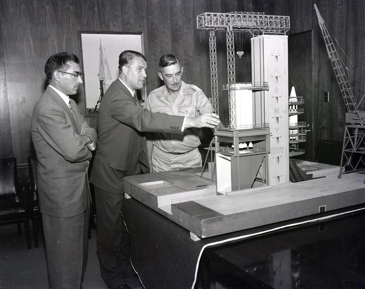 (From left to right) Karl L. Heimburg, Director of the Test Laboratory; Dr. Wernher von Braun, Director of the Development Operation Division; and Major General John B. Medaris with the model of S-1B Test Stand. Gen. Medaris was a Commander of the Army Ballistic Missile Agency (ABMA) in Redstone Arsenal, Alabama, during 1955 to 1958.