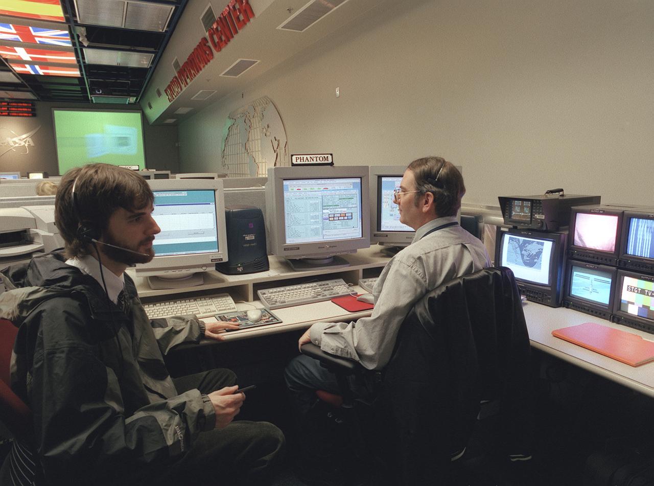 The Payload Operations Center (POC) is the science command post for the International Space Station (ISS). Located at NASA's Marshall Space Flight Center in Huntsville, Alabama, it is the focal point for American and international science activities aboard the ISS. The POC's unique capabilities allow science experts and researchers around the world to perform cutting-edge science in the unique microgravity environment of space. The POC is staffed around the clock by shifts of payload flight controllers. At any given time, 8 to 10 flight controllers are on consoles operating, plarning for, and controlling various systems and payloads. This photograph shows the Photo and TV Operations Manager (PHANTOM) at a work station. The PHANTOM configures all video systems aboard the ISS and ensures they are working properly, providing a video link from the ISS to the POC. 