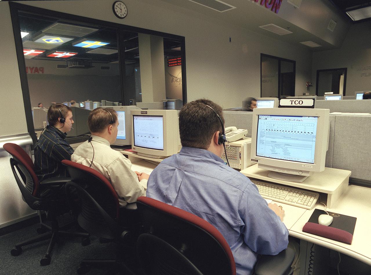 The Payload Operations Center (POC) is the science command post for the International Space Station (ISS). Located at NASA's Marshall Space Flight Center in Huntsville, Alabama, it is the focal point for American and international science activities aboard the ISS. The POC's unique capabilities allow science experts and researchers around the world to perform cutting-edge science in the unique microgravity environment of space. The POC is staffed around the clock by shifts of payload flight controllers. At any given time, 8 to 10 flight controllers are on consoles operating, plarning for, and controlling various systems and payloads. This photograph shows the Timeline Change Officer (TCO) at a work station. The TCO maintains the daily schedule of science activities and work assignments, and works with planners at Mission Control at Johnson Space Center in Houston, Texas, to ensure payload activities are accommodated in overall ISS plans and schedules. 
