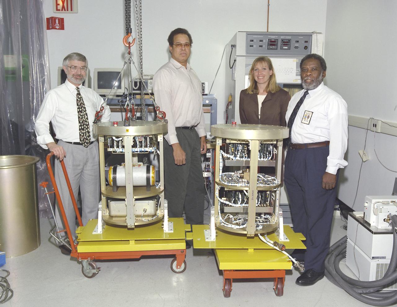 The Critical Viscosity of Xenon Experiment (CVX-2) on the STS-107 Research 1 mission in 2002 will measure the viscous behavior of xenon, a heavy inert gas used in flash lamps and ion rocket engines, at its critical point. The thermostat for CVX sits inside the white cylinder on a support structure (at left) that is placed inside a pressure canister. A similar canister (right) holds the electronics and control systems. The CVX-2 arrangement is identical. The principal investigator is Dr. Robert F. Berg (not shown) of the National Institutes of Standards and Technology, Gaithersburg, MD.