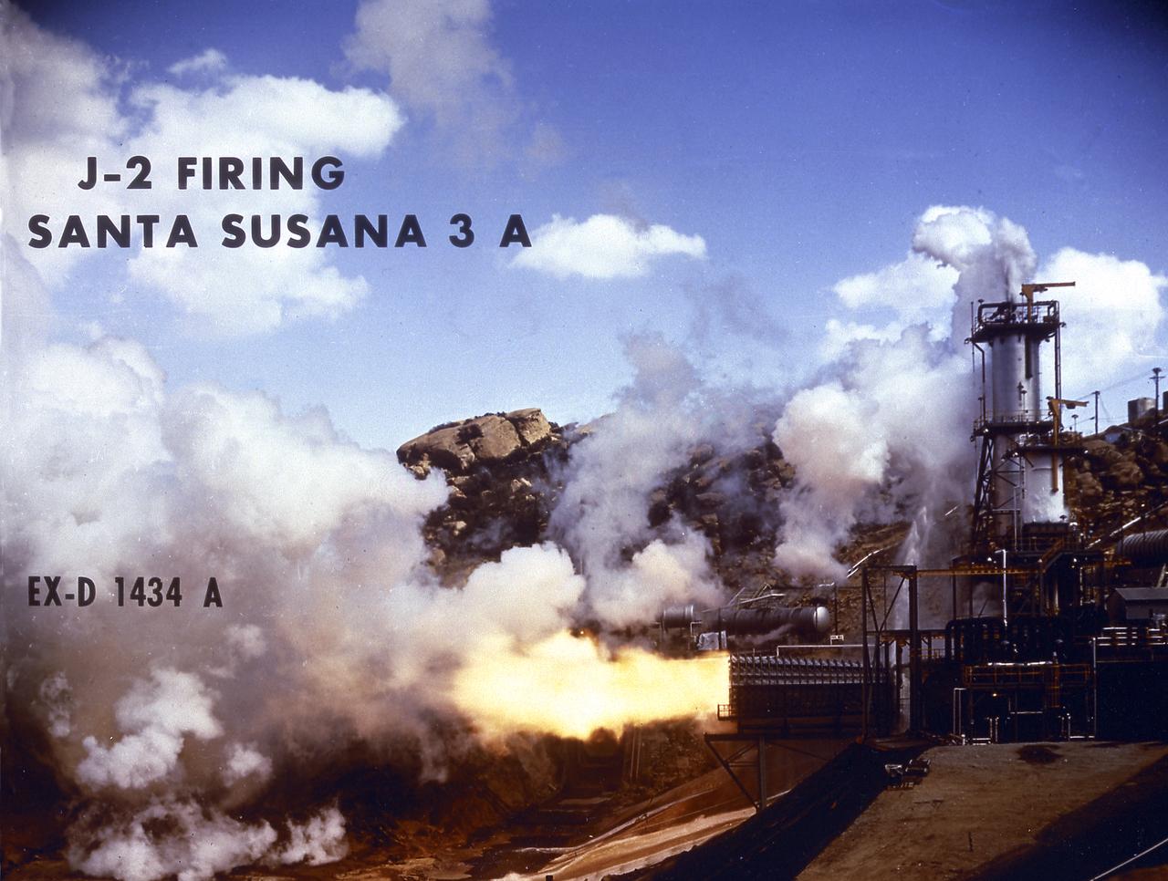 Smokeless flame juts from the diffuser of a unique vacuum chamber in which the upper stage rocket engine, the hydrogen fueled J-2, was tested at a simulated space altitude in excess of 60,000 feet. The smoke you see is actually steam. In operation, vacuum is established by injecting steam into the chamber and is maintained by the thrust of the engine firing through the diffuser. The engine was tested in this environment for start, stop, coast, restart, and full-duration operations. The chamber was located at Rocketdyne's Propulsion Field Laboratory, in the Santa Susana Mountains, near Canoga Park, California. The J-2 engine was developed by Rocketdyne for the Marshall Space Flight Center.