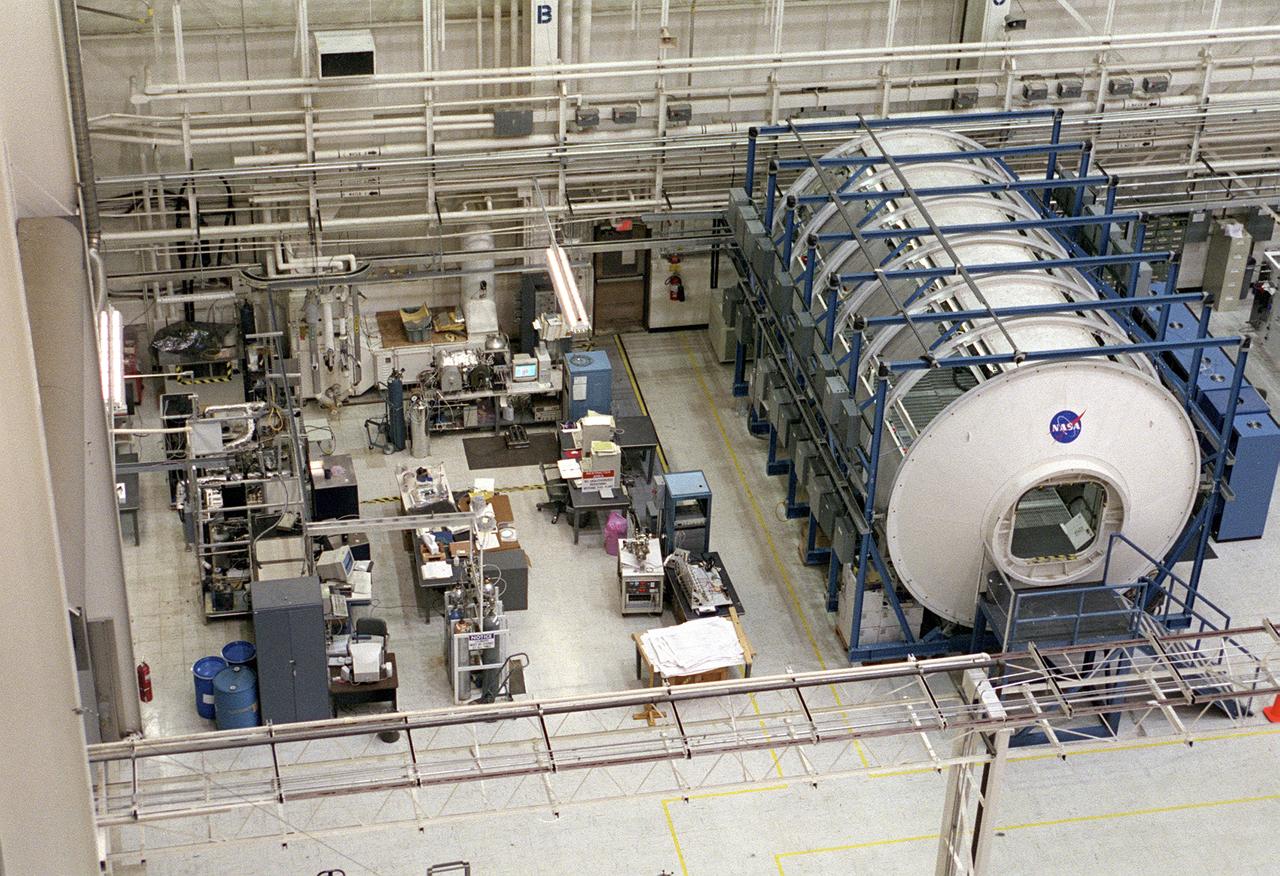 The Marshall Space Flight Center (MSFC) is responsible for designing and building the life support systems that will provide the crew of the International Space Station (ISS) a comfortable environment in which to live and work. Scientists and engineers at the MSFC are working together to provide the ISS with systems that are safe, efficient, and cost-effective. These compact and powerful systems are collectively called the Environmental Control and Life Support Systems, or simply, ECLSS. In this photograph, the life test area on the left of the MSFC ECLSS test facility is where various subsystems and components are tested to determine how long they can operate without failing and to identify components needing improvement. Equipment tested here includes the Carbon Dioxide Removal Assembly (CDRA), the Urine Processing Assembly (UPA), the mass spectrometer filament assemblies and sample pumps for the Major Constituent Analyzer (MCA). The Internal Thermal Control System (ITCS) simulator facility (in the module in the right) duplicates the function and operation of the ITCS in the ISS U.S. Laboratory Module, Destiny. This facility provides support for Destiny, including troubleshooting problems related to the ITCS. 