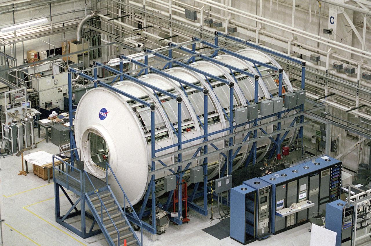 The Marshall Space Flight Center (MSFC) is responsible for designing and building the life support systems that will provide the crew of the International Space Station (ISS) a comfortable environment in which to live and work. Scientists and engineers at the MSFC are working together to provide the ISS with systems that are safe, efficient and cost-effective. These compact and powerful systems are collectively called the Environmental Control and Life Support Systems, or simply, ECLSS. This is an exterior view of the U.S. Laboratory Module Simulator containing the ECLSS Internal Thermal Control System (ITCS) testing facility at MSFC. At the bottom right is the data acquisition and control computers (in the blue equipment racks) that monitor the testing in the facility. The ITCS simulator facility duplicates the function, operation, and troubleshooting problems of the ITCS. The main function of the ITCS is to control the temperature of equipment and hardware installed in a typical ISS Payload Rack. 